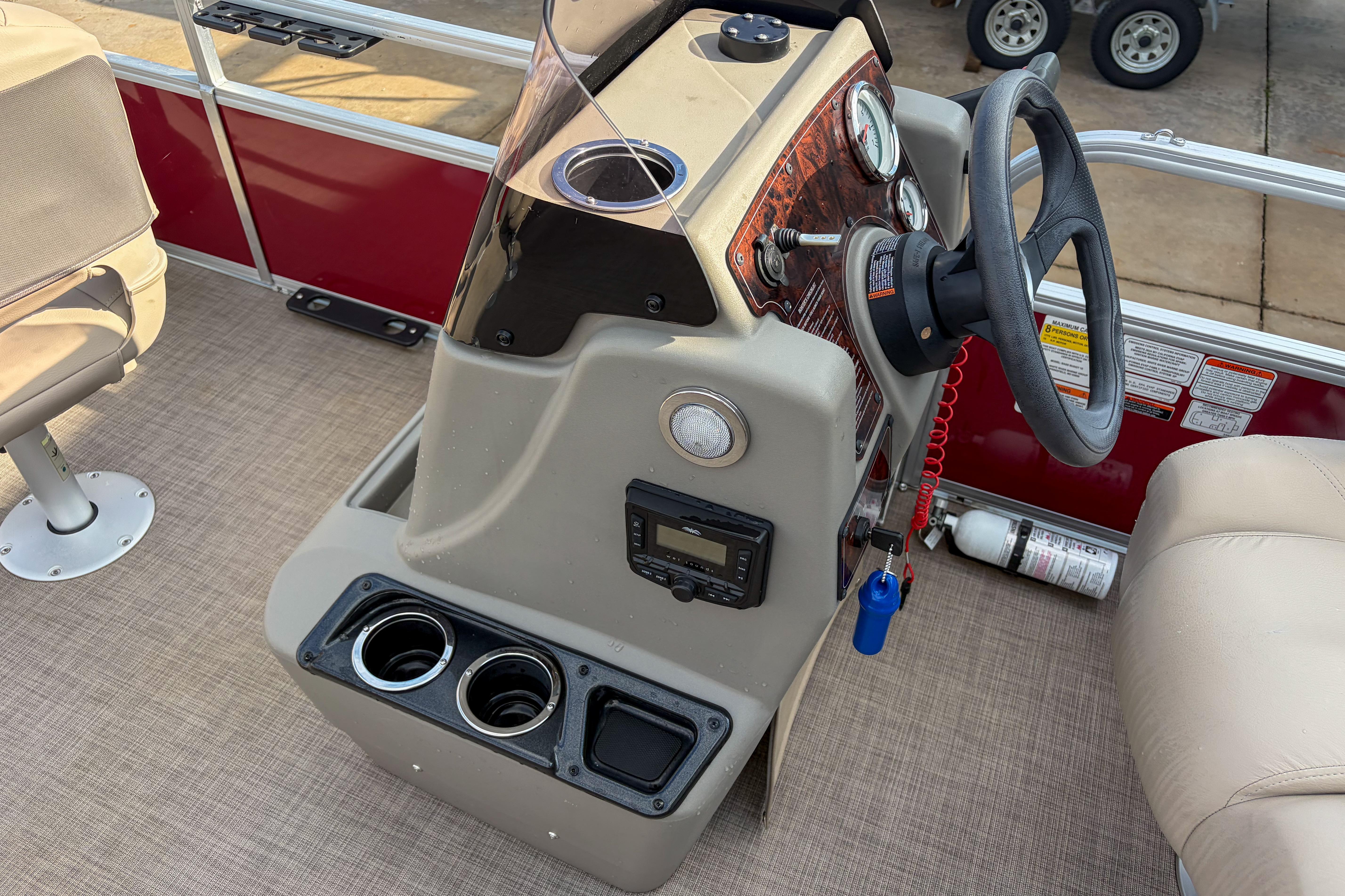 2024 Sun Tracker Bass Buggy 18 DLX boat console with steering wheel and controls.