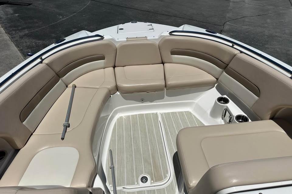 Spacious seating area on 2012 Chaparral 284 Sunesta boat with beige upholstery.