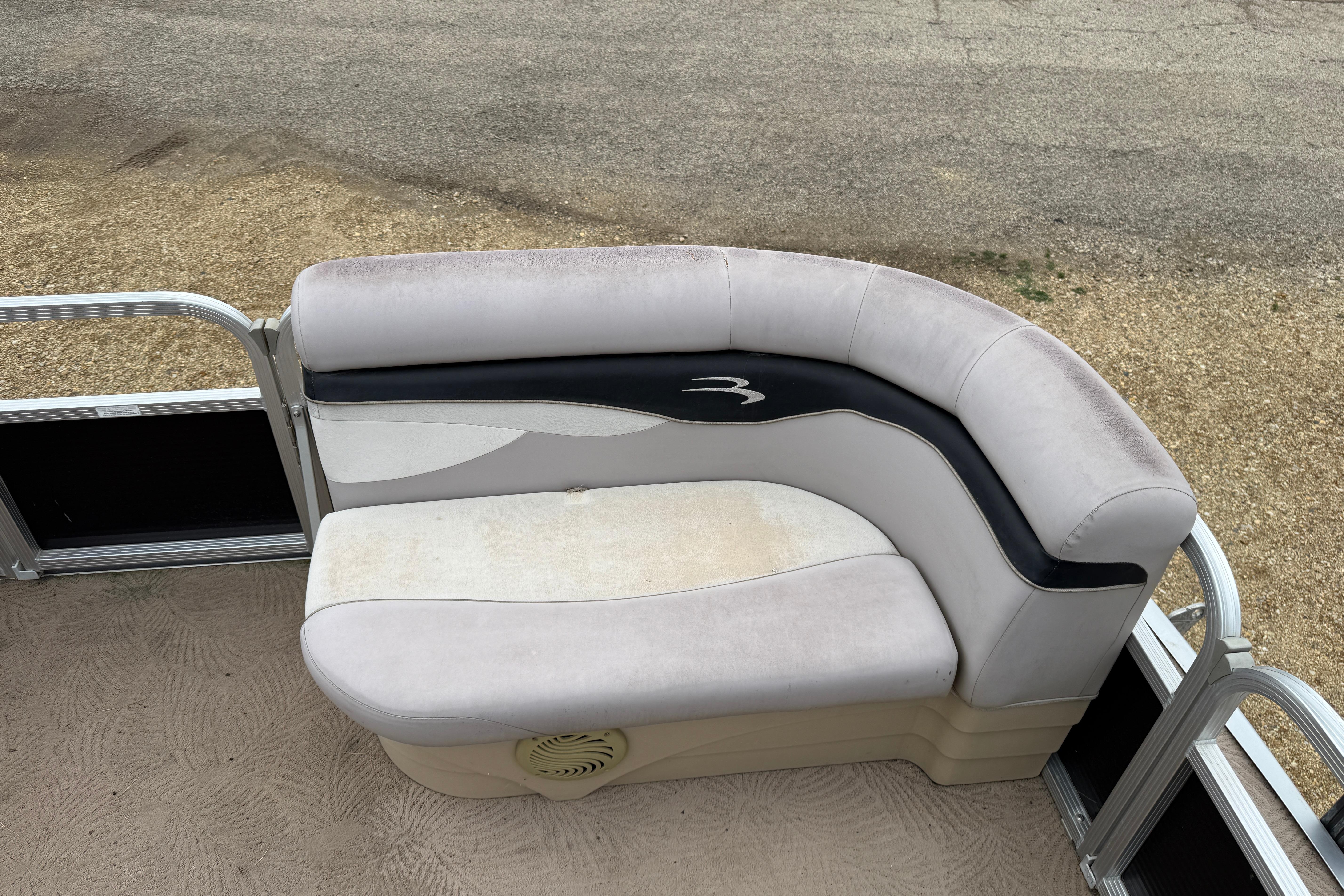 2010 Bennington 20SLi pontoon boat seat with beige and black upholstery.