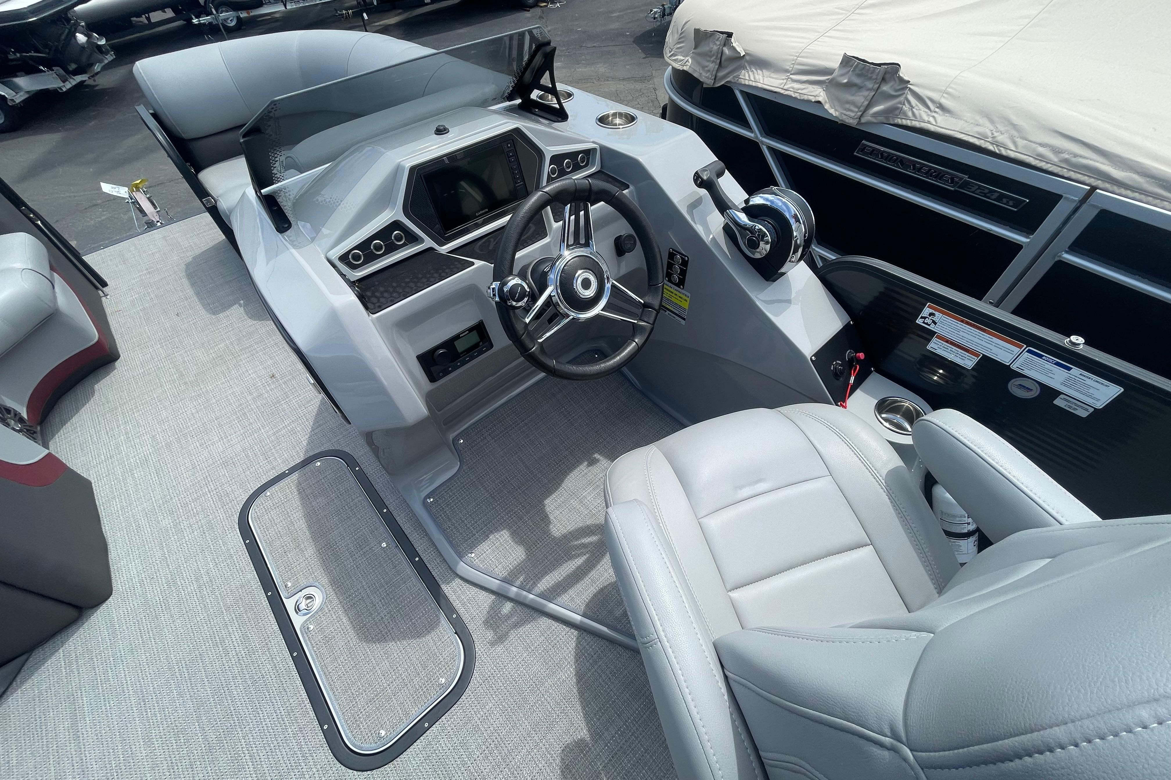 2022 Manitou 23 Oasis boat interior with modern steering console and comfortable seating.