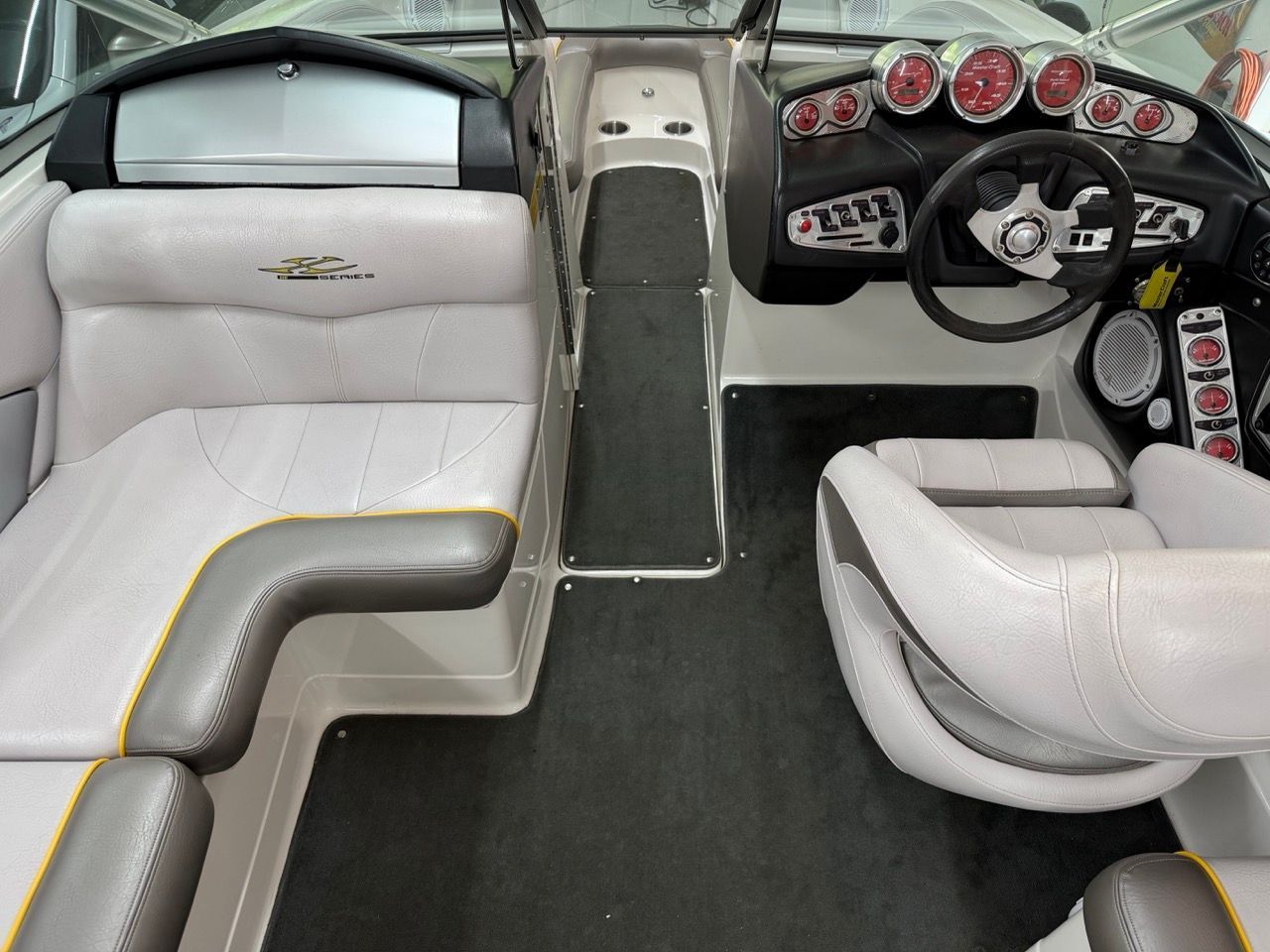 Interior of a 2006 MasterCraft X30 with gray upholstery, modern dashboard, and steering wheel.
