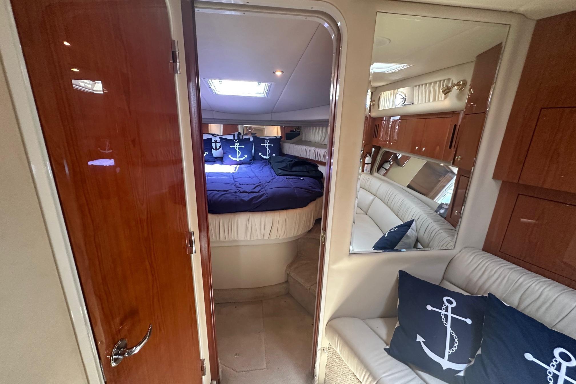 Interior of 2001 Sea Ray 410 Sundancer yacht with cozy cabin and nautical decor.
