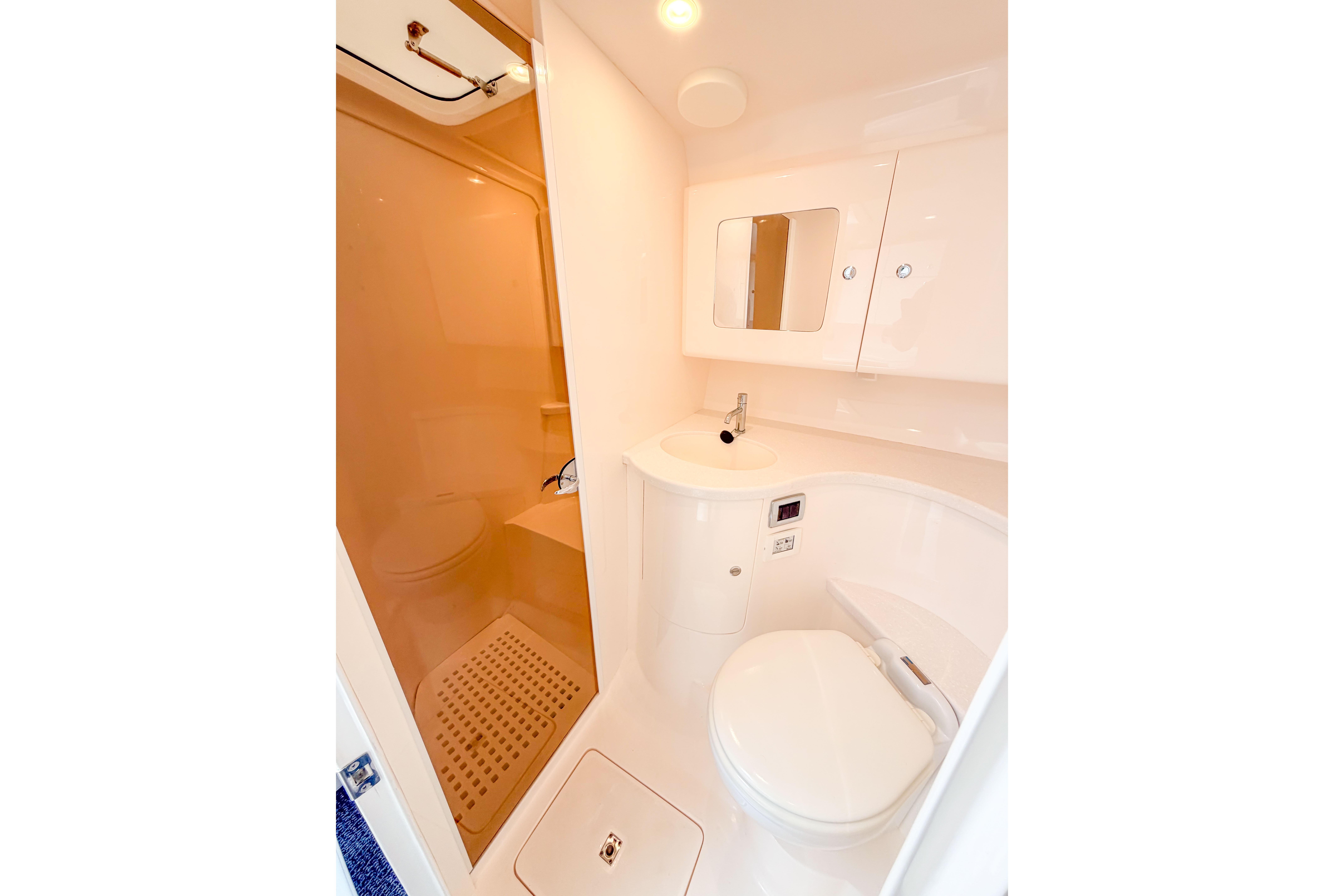 2021 Intrepid 409 Valor boat bathroom with modern fixtures and compact design.