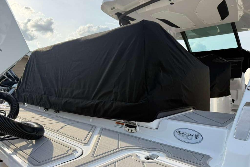 2026 Monterey Elite 30 OB boat with covered seating area on deck.
