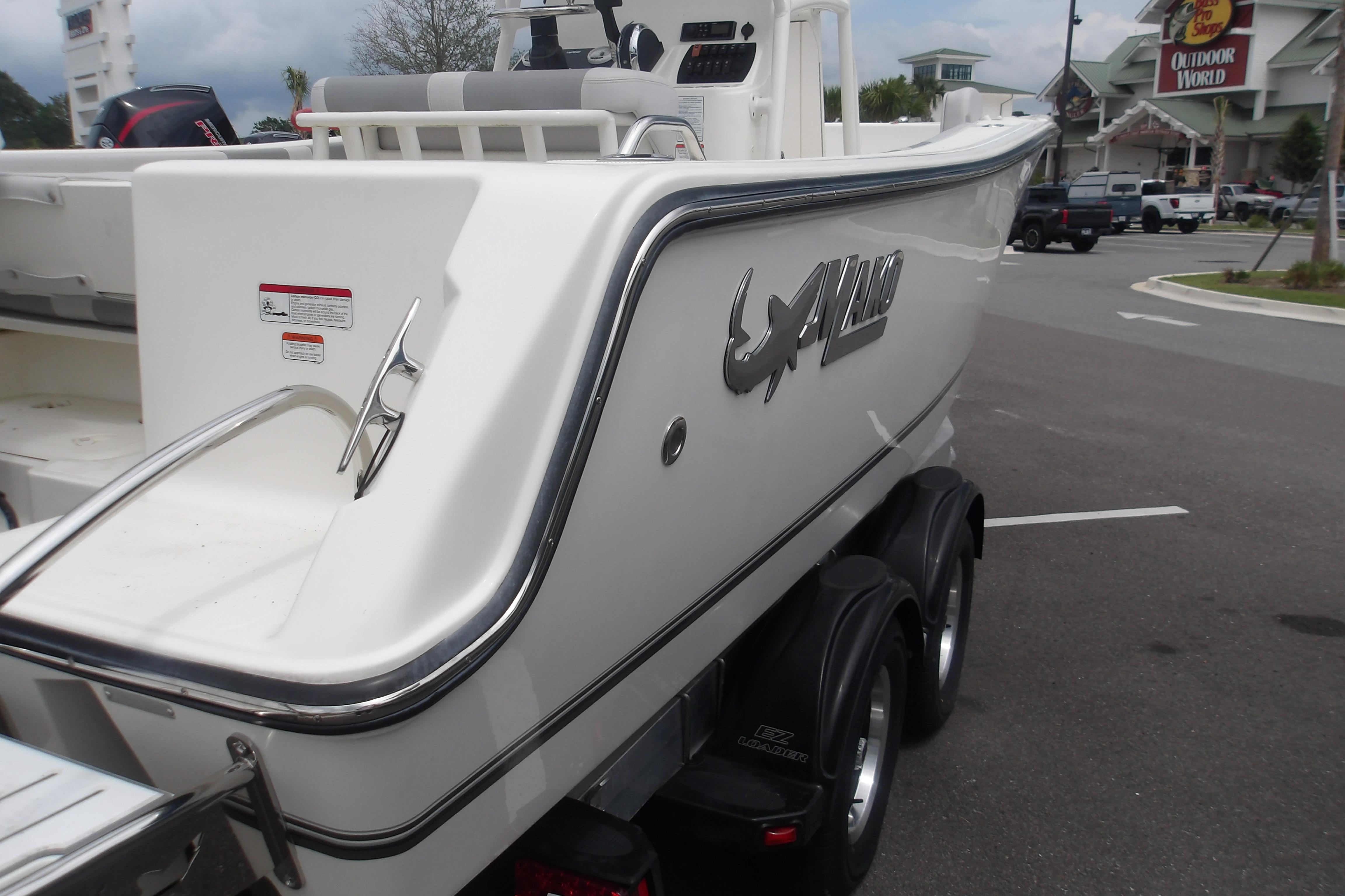 2025 Mako 214 Center Console boat on trailer in parking lot.