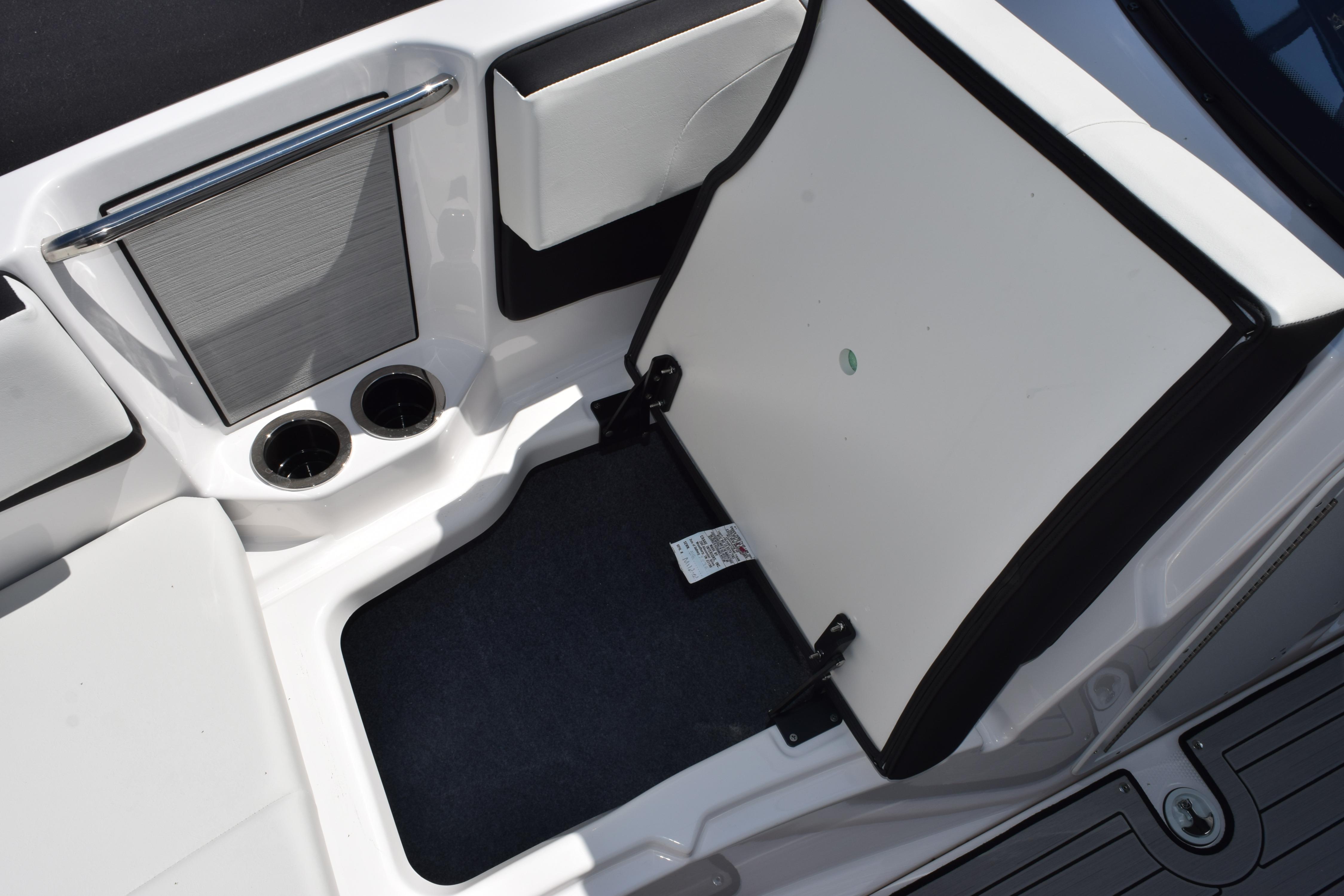 2026 Yamaha Boats 222SE interior storage compartment with cup holders and sleek design.
