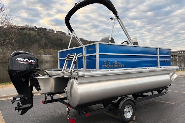 2026 Sun Tracker Party Barge 16 DLX pontoon boat with Mercury engine on trailer.