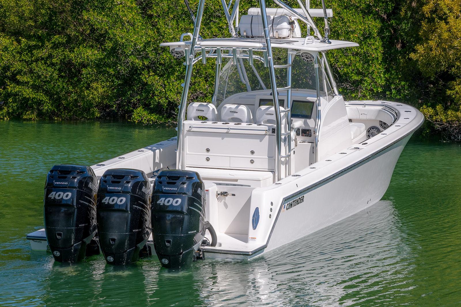2022 Contender 39 Fisharound boat with triple 400 horsepower engines on calm water.