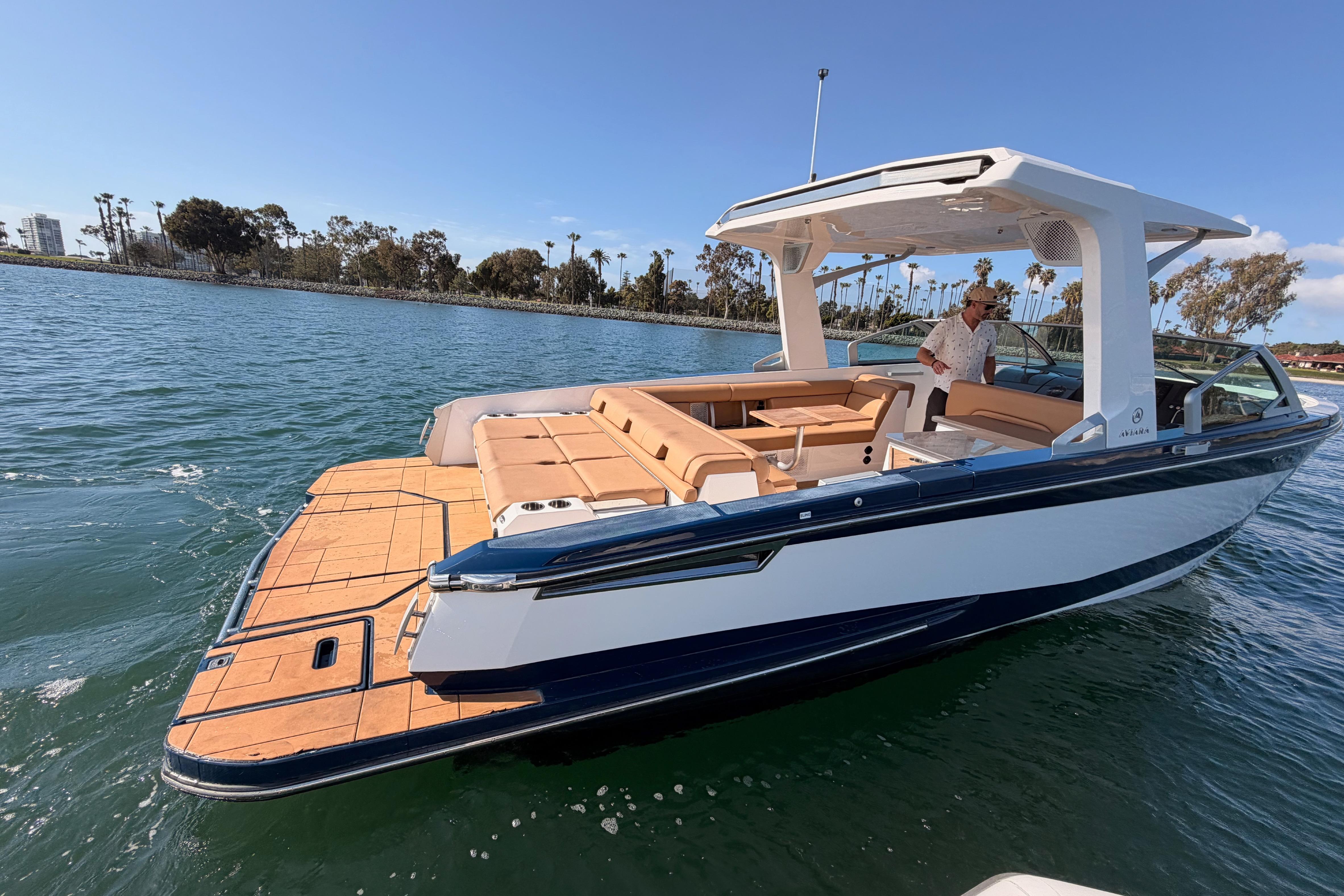 2022 Aviara AV32 I/O boat on water, featuring sleek design and spacious seating.