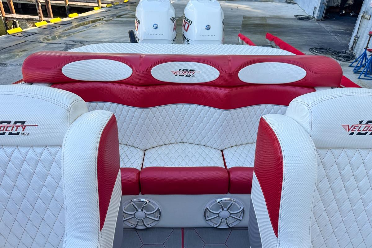 2022 Velocity 290sc boat interior with red and white seating, dockside view.