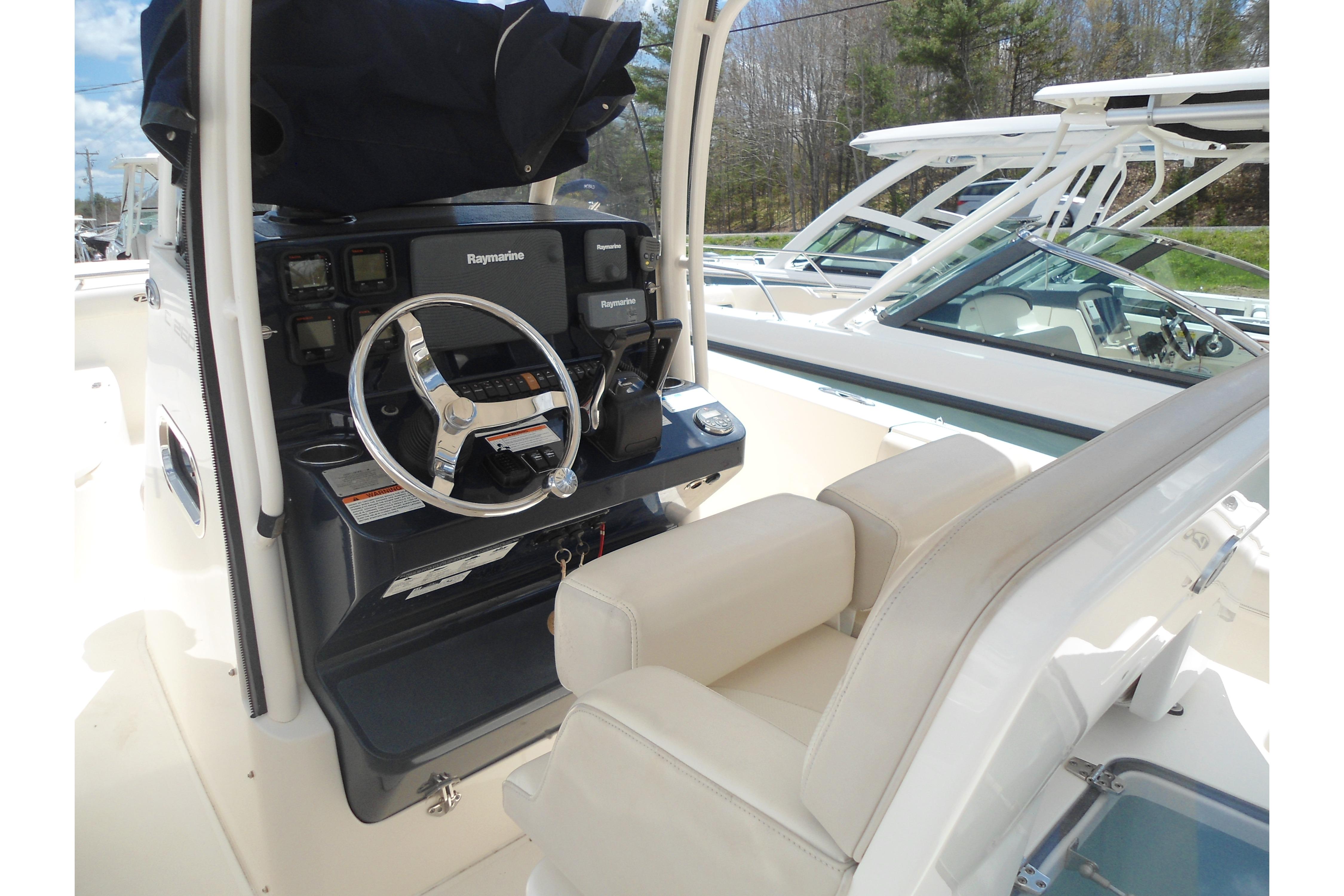 2013 Pursuit C 260 Center Console boat interior with steering wheel and Raymarine electronics.