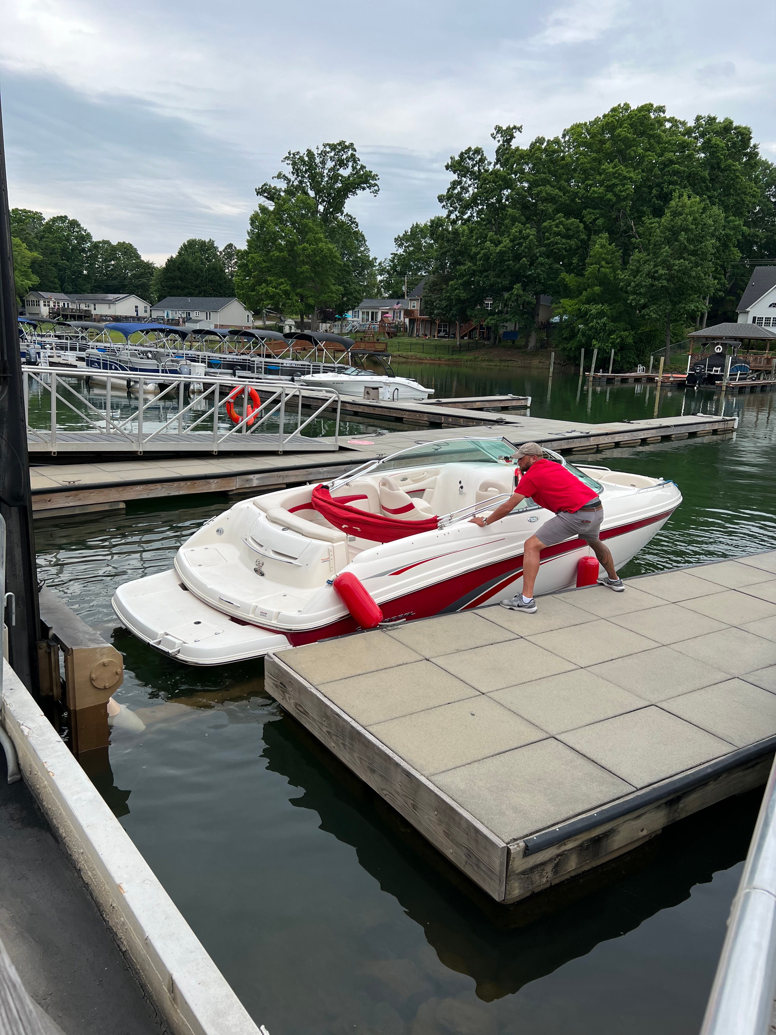 Chaparral 230 SSi boat at dock with person, 2000 model.