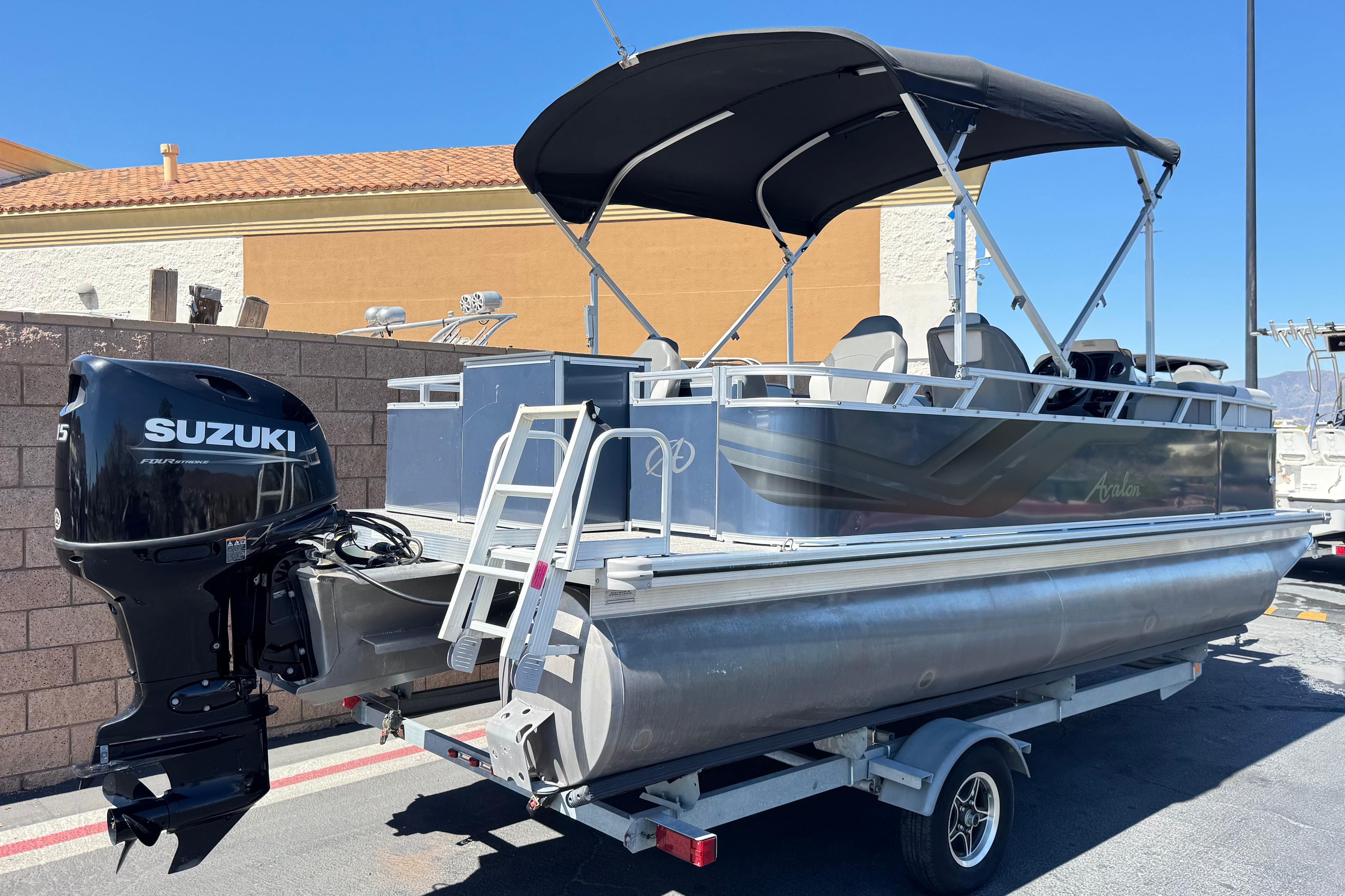 2023 Avalon Venture Fish N Cruise 20' pontoon boat with Suzuki outboard motor on trailer.