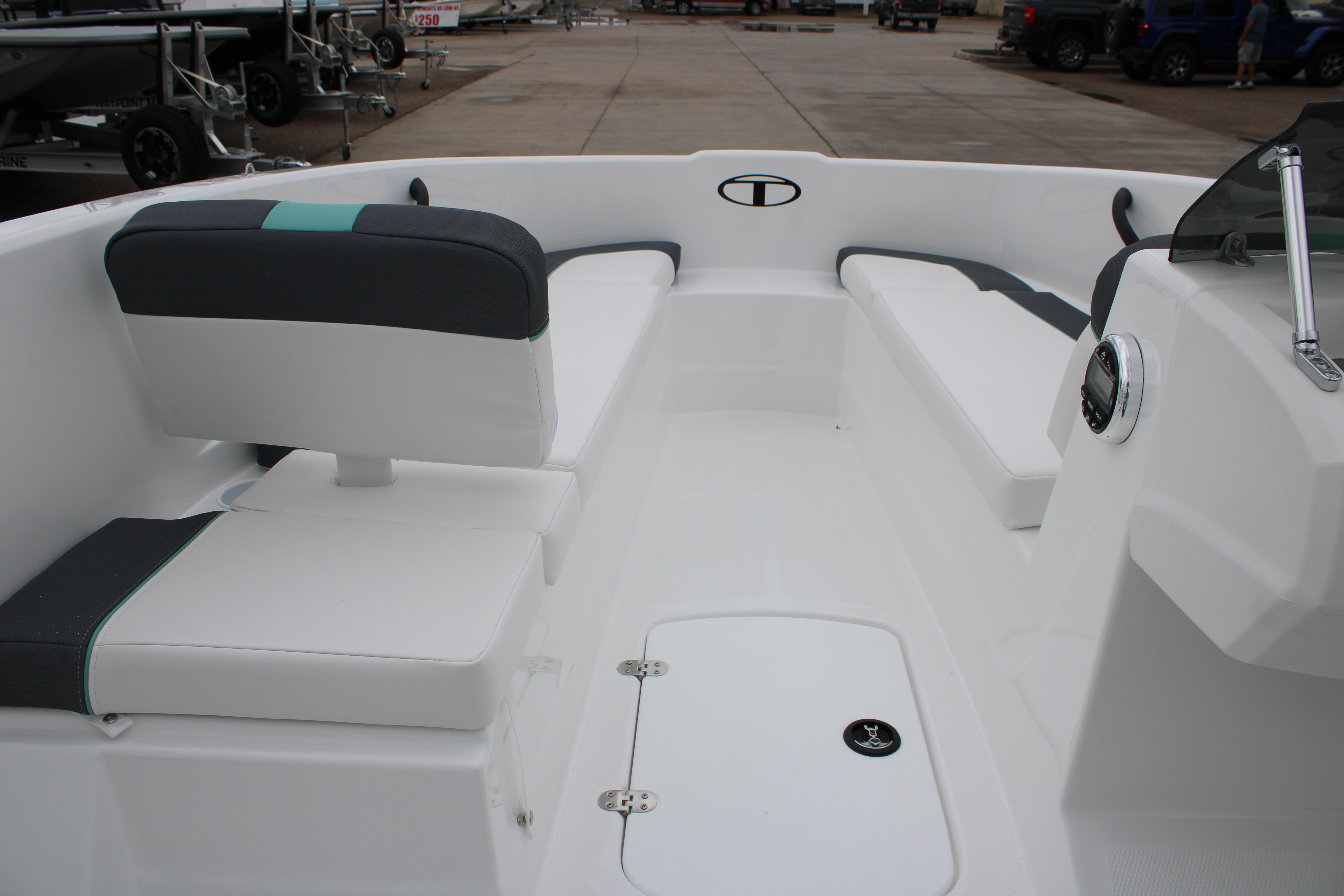 Interior view of 2026 Tahoe T16 boat, featuring sleek white seating and modern design.