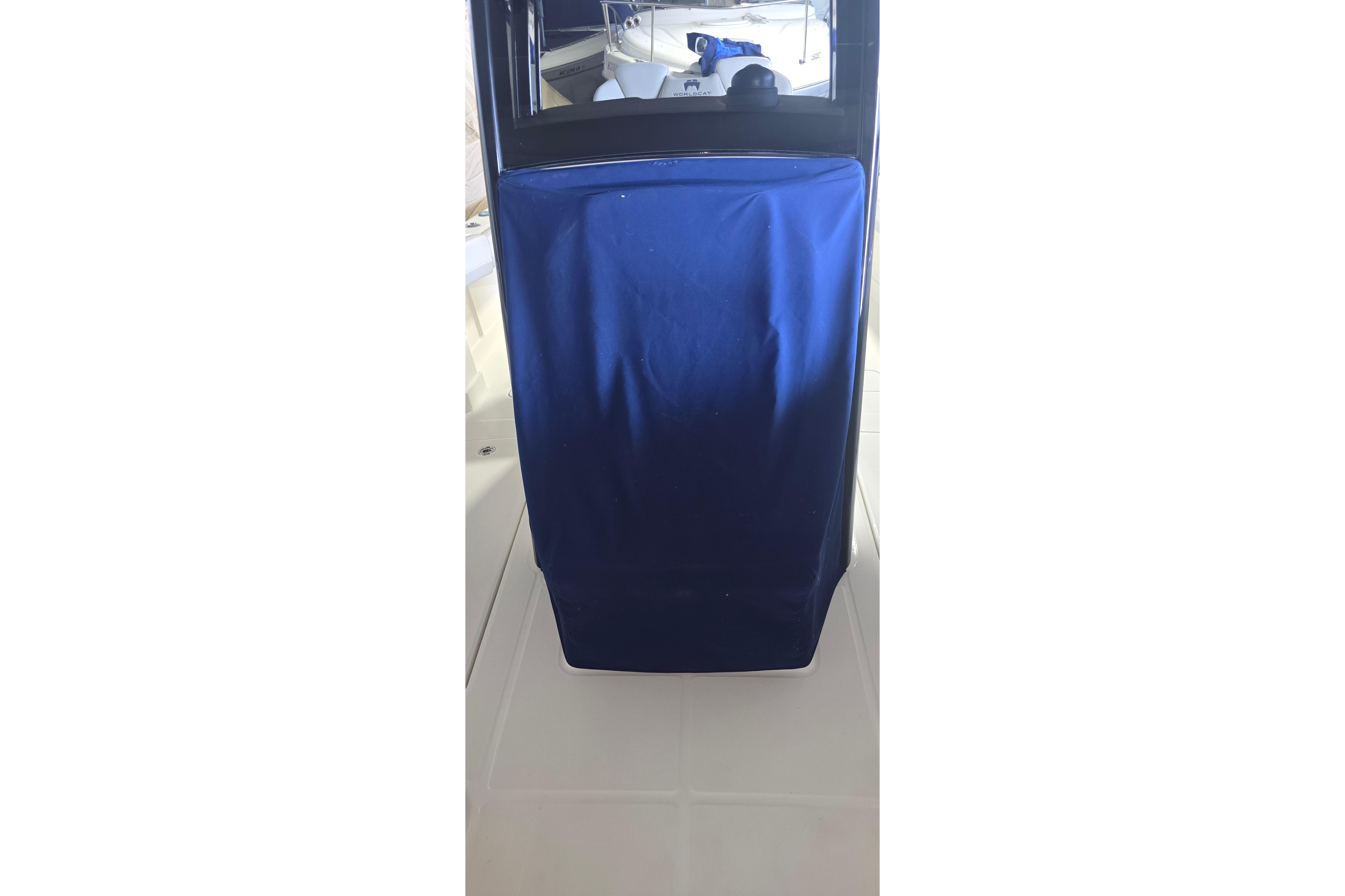 2024 WorldCat 280 CC-X boat interior with blue cover and window reflection.