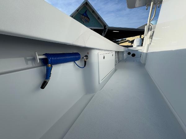 2025 Yellowfin 39 Offshore boat interior with hose and storage compartments.