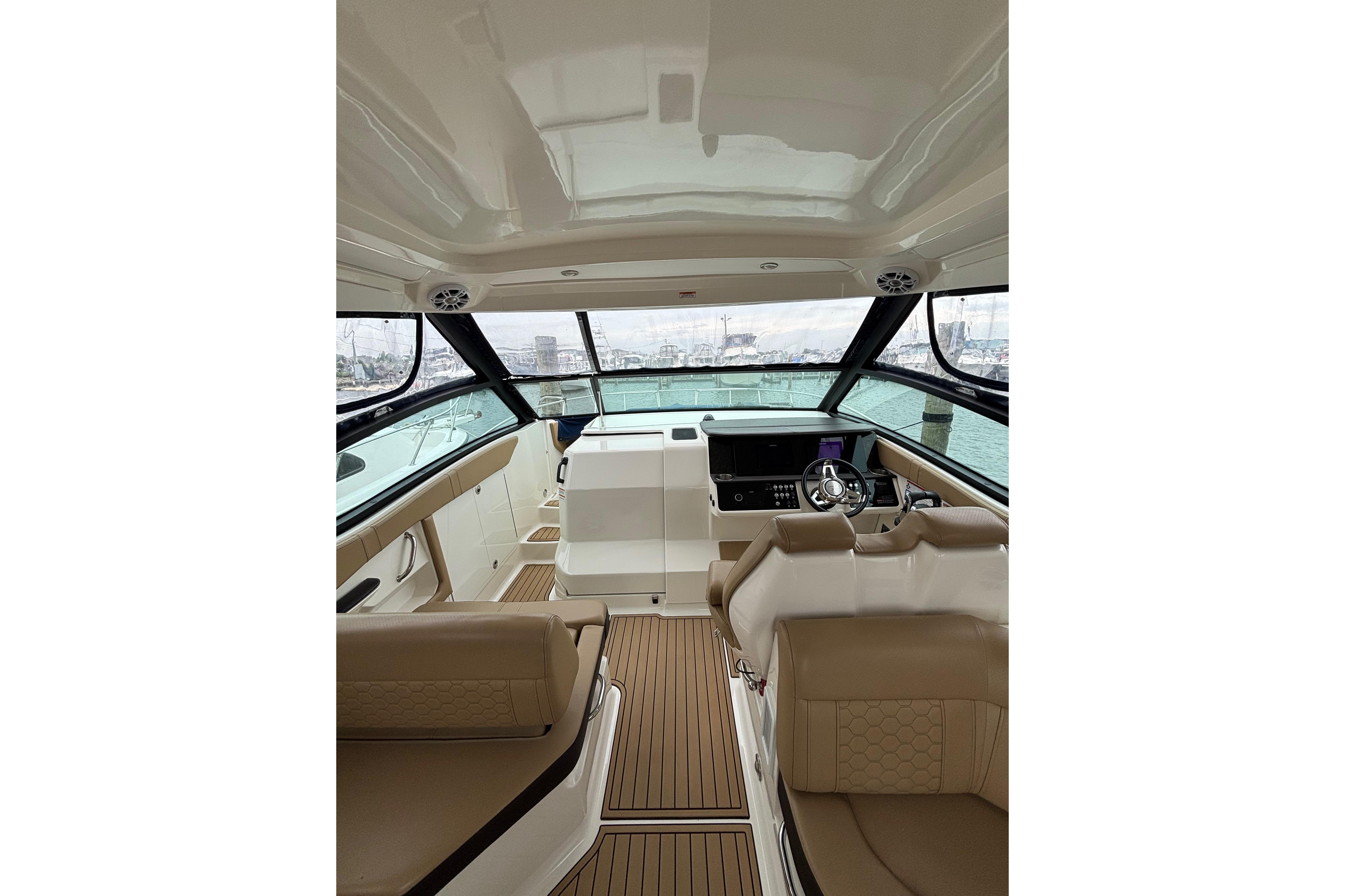 2021 Sea Ray Sundancer 320 Outboard interior with helm, seating, and panoramic windows.