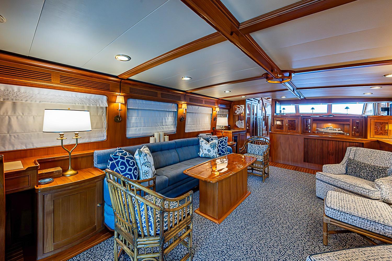 Luxurious interior of 2014 Marlow 80 Explorer yacht with elegant wood finishes and plush seating.
