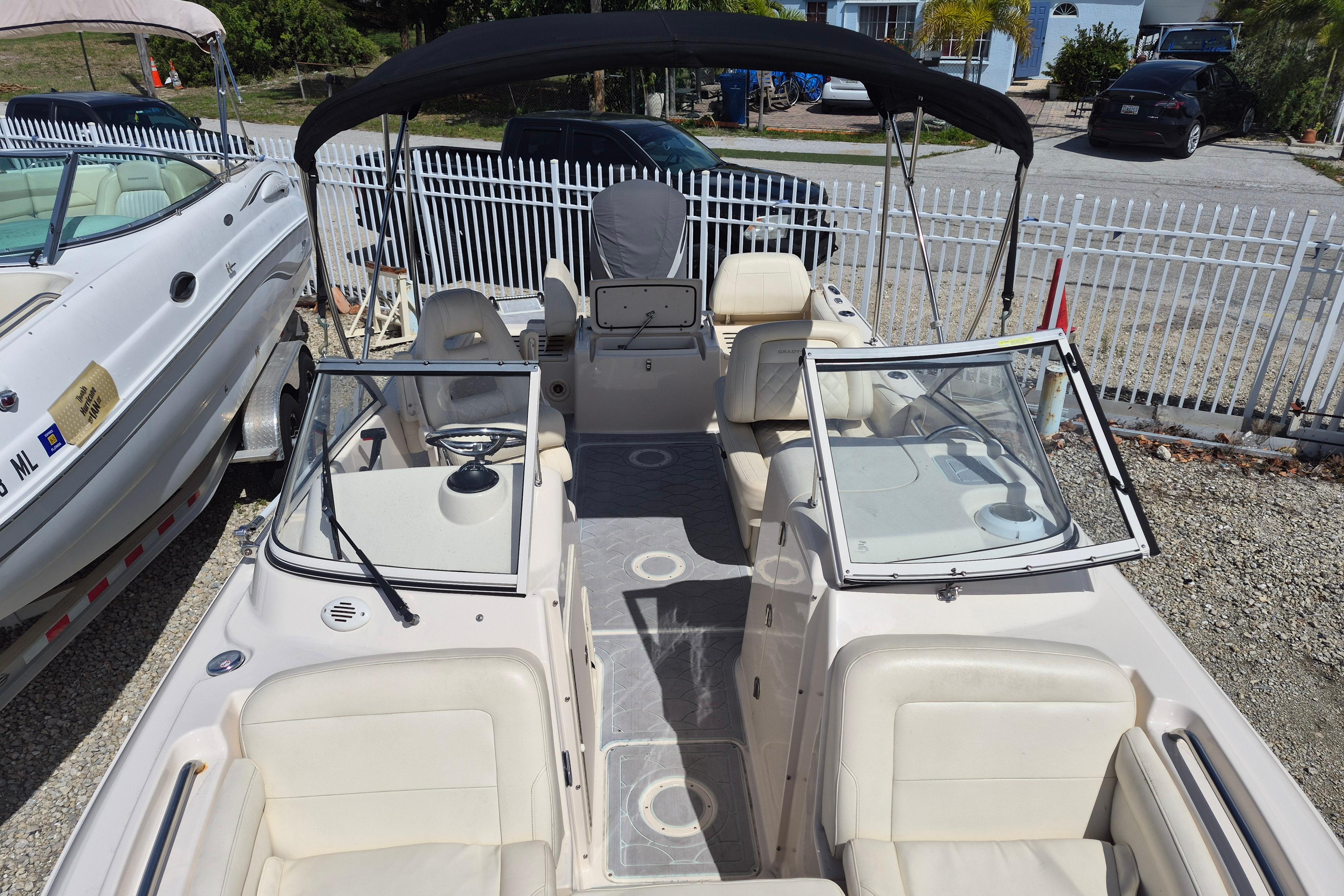 2023 Grady-White Freedom 215 boat with spacious seating and sleek design, docked outdoors.