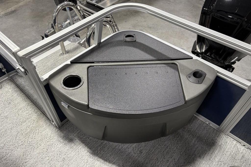 2026 Sun Tracker Bass Buggy 18 DLX boat interior with storage compartment and cup holders.