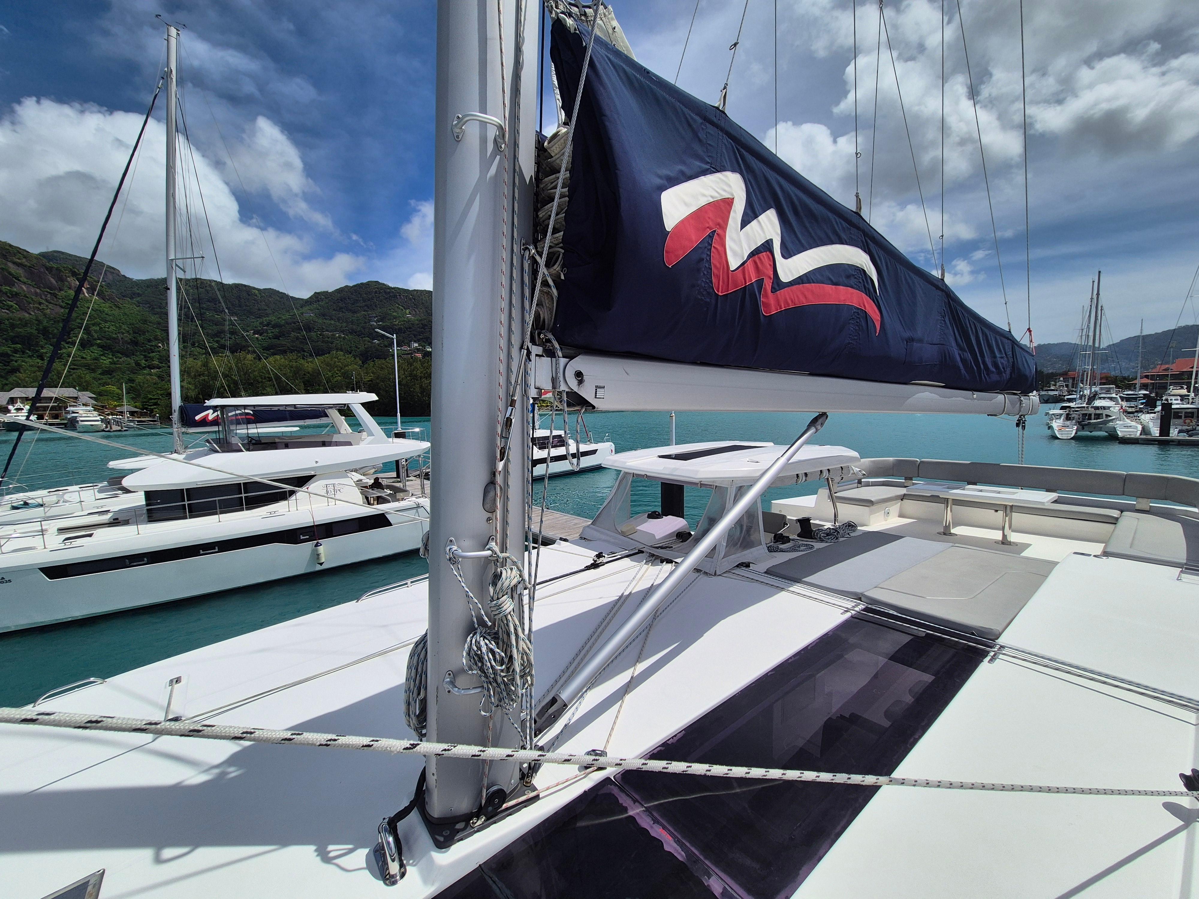 2020 Leopard 50 catamaran docked in a scenic marina with clear blue waters.