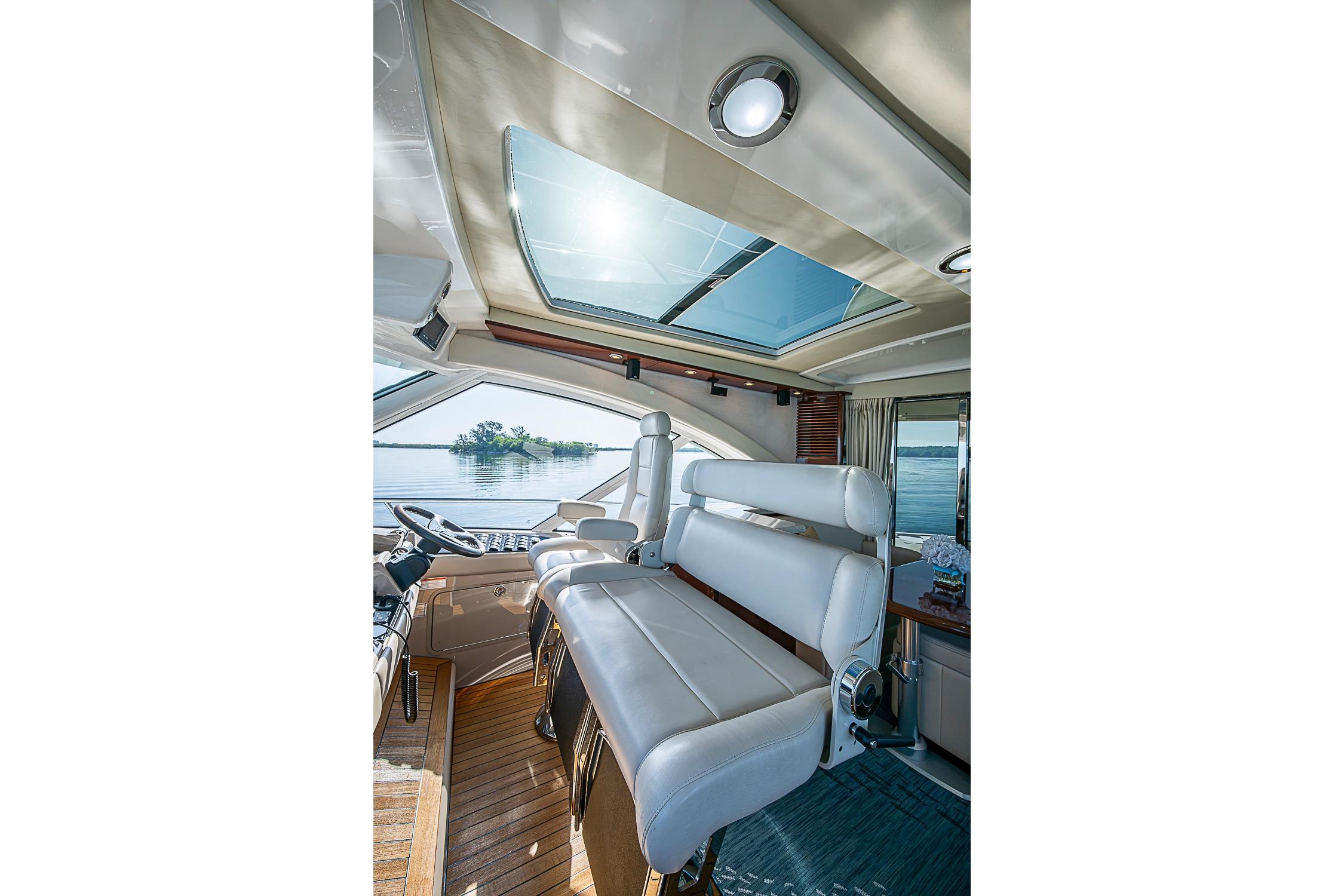Luxurious interior of 2008 Sea Ray 60 Sundancer yacht with panoramic windows and plush seating.