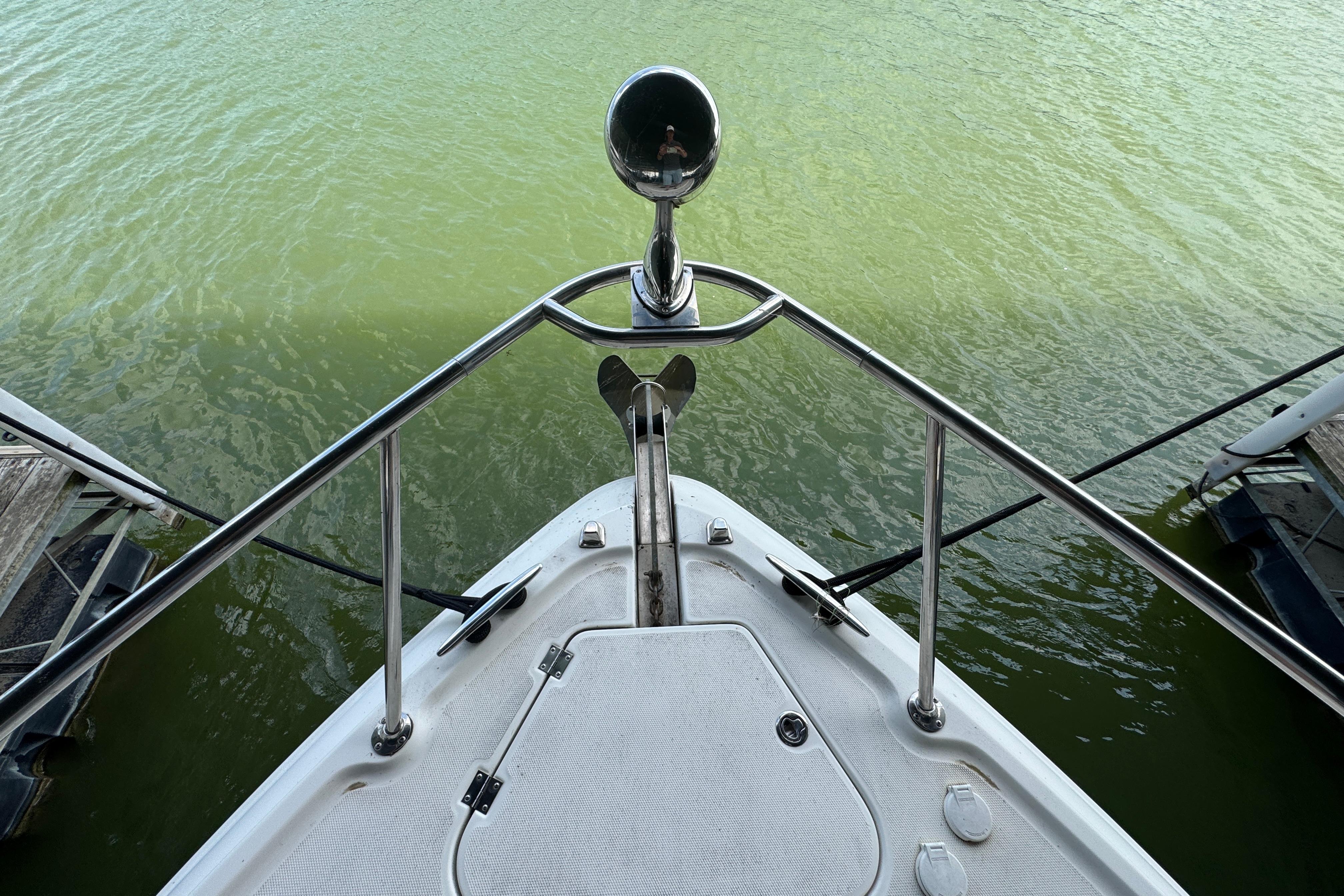 Bow view of 2006 Chaparral 330 Signature boat on green water.
