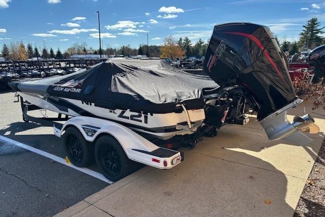 2025 Nitro Z21 XL boat with cover and powerful outboard motor in parking lot.