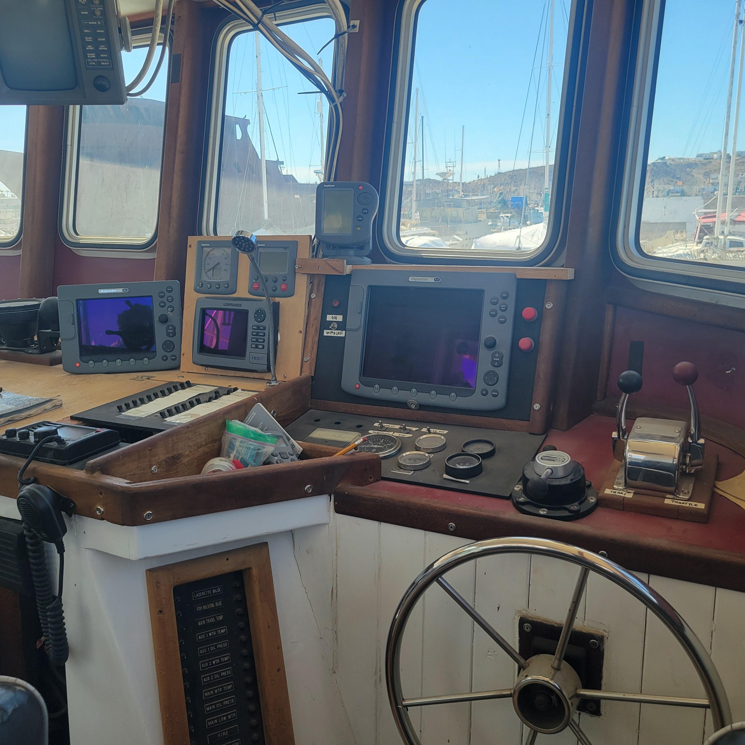 1979 Shrimper Conversion Trawler cockpit with navigation equipment and steering wheel.