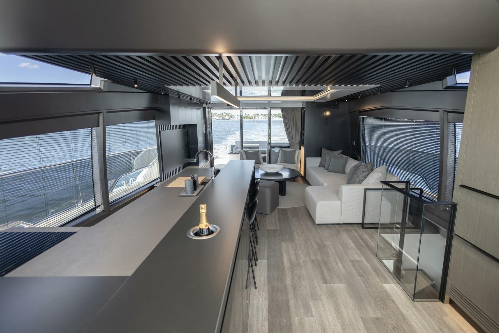 Luxurious interior of 2023 Pearl 72 yacht with modern design and waterfront view.