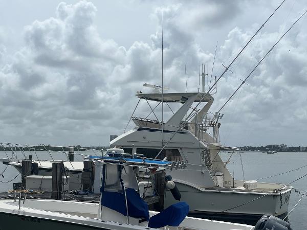 1985 Hatteras 45 Convertible yacht docked under cloudy skies.