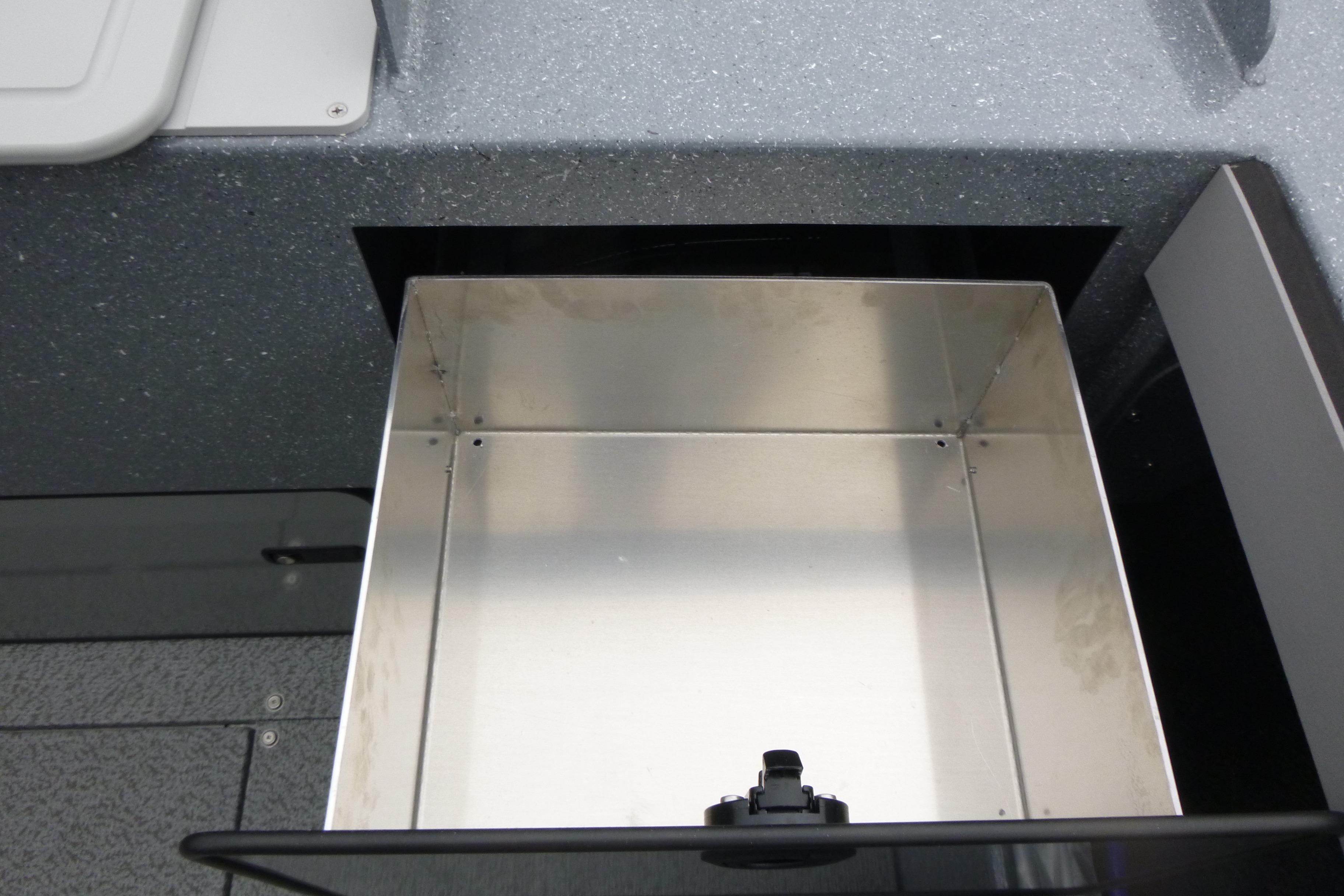 Storage compartment in 2026 KingFisher 2025 Escape boat, featuring sleek metallic interior design.