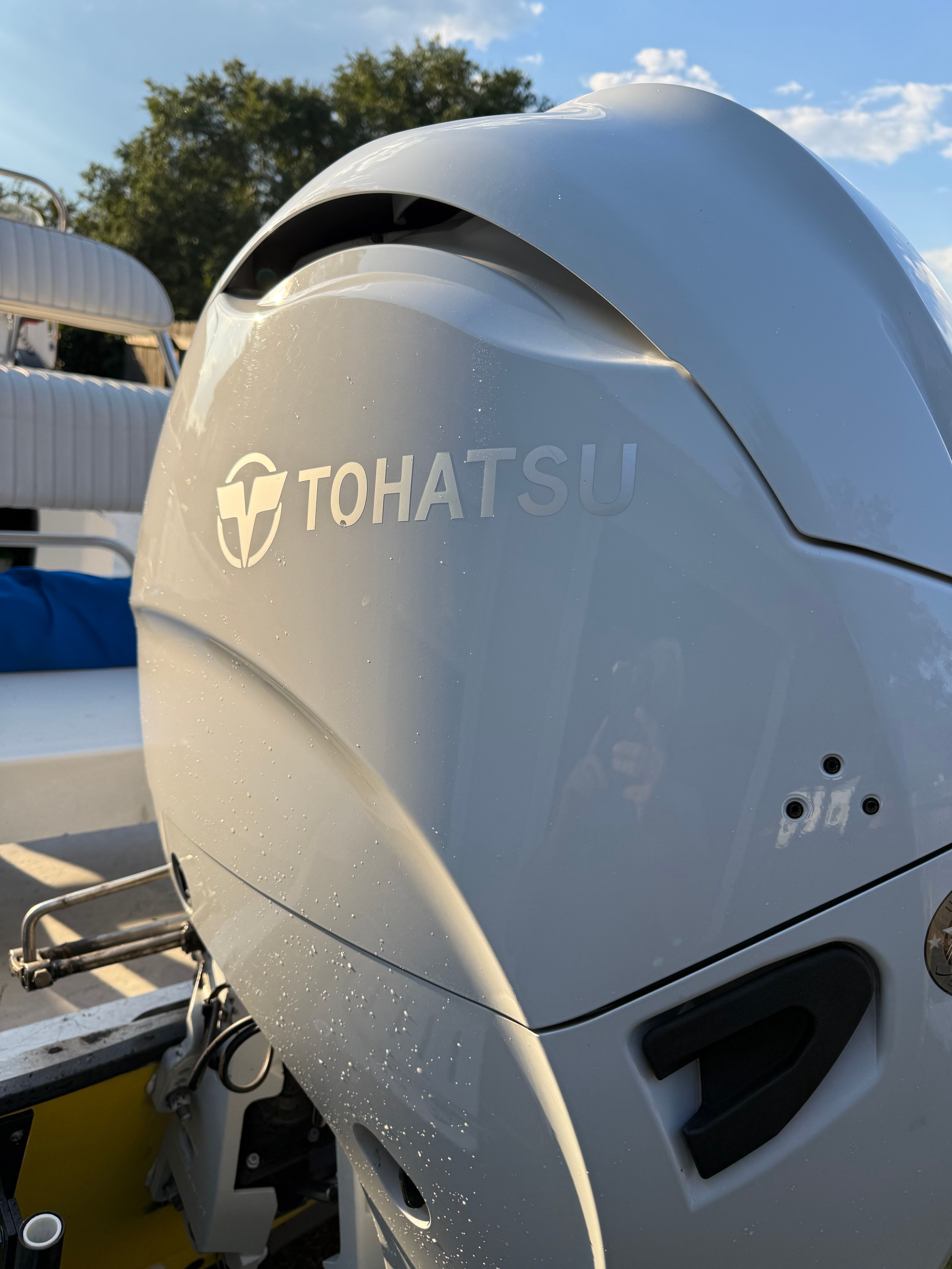Close-up of a Tohatsu outboard motor on a boat.