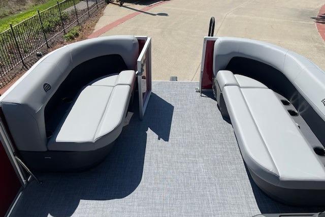 2026 Sun Tracker Party Barge 16 DLX interior with gray seating and open deck.