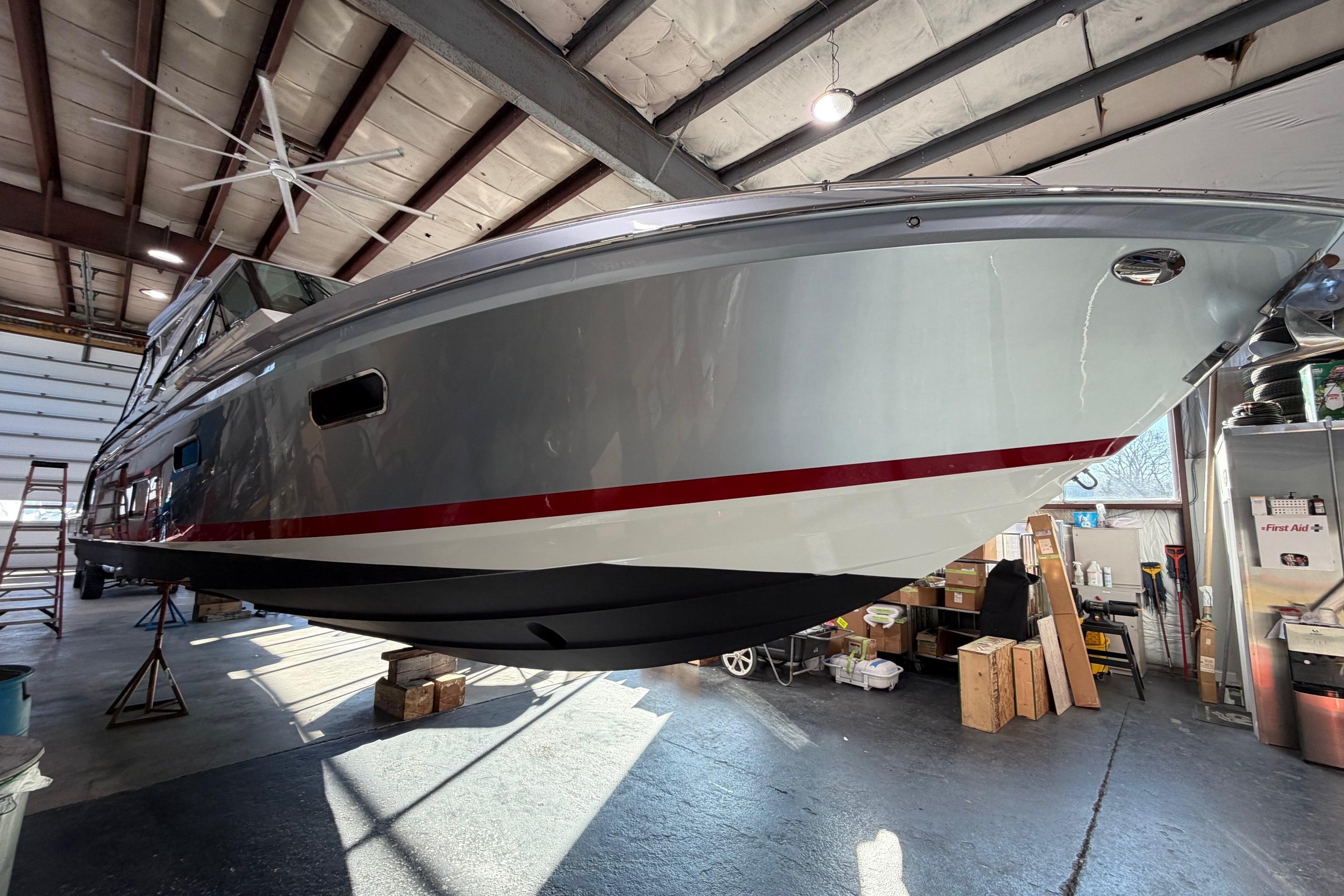 2017 Formula 430 Super Sport Crossover boat in a warehouse, elevated for maintenance.