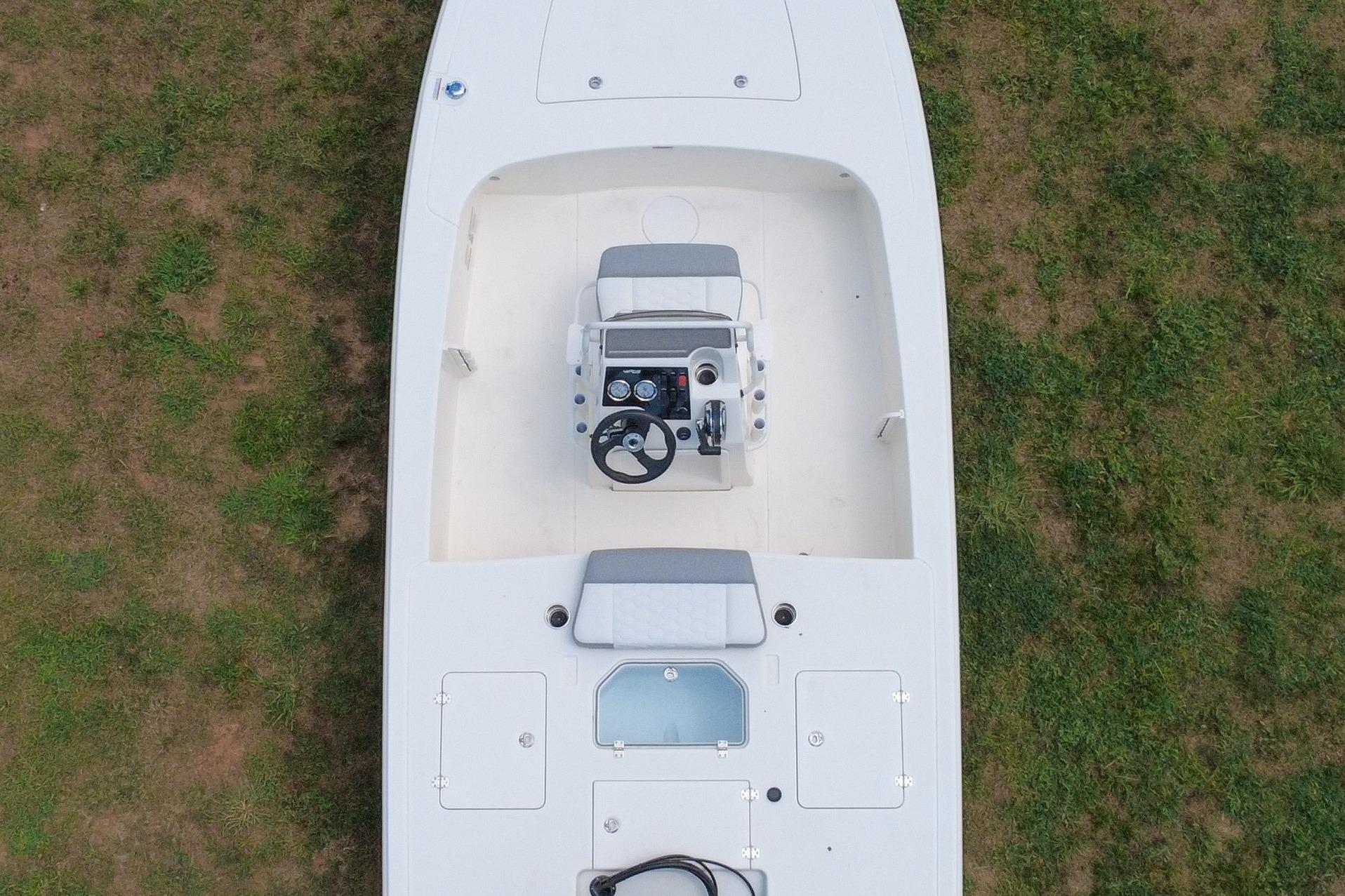 Top view of a 2026 Mako 18 Pro Skiff boat on grass.