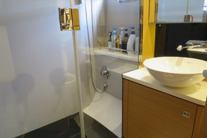Modern bathroom in 2016 Princess V48 yacht with glass shower and sleek sink design.