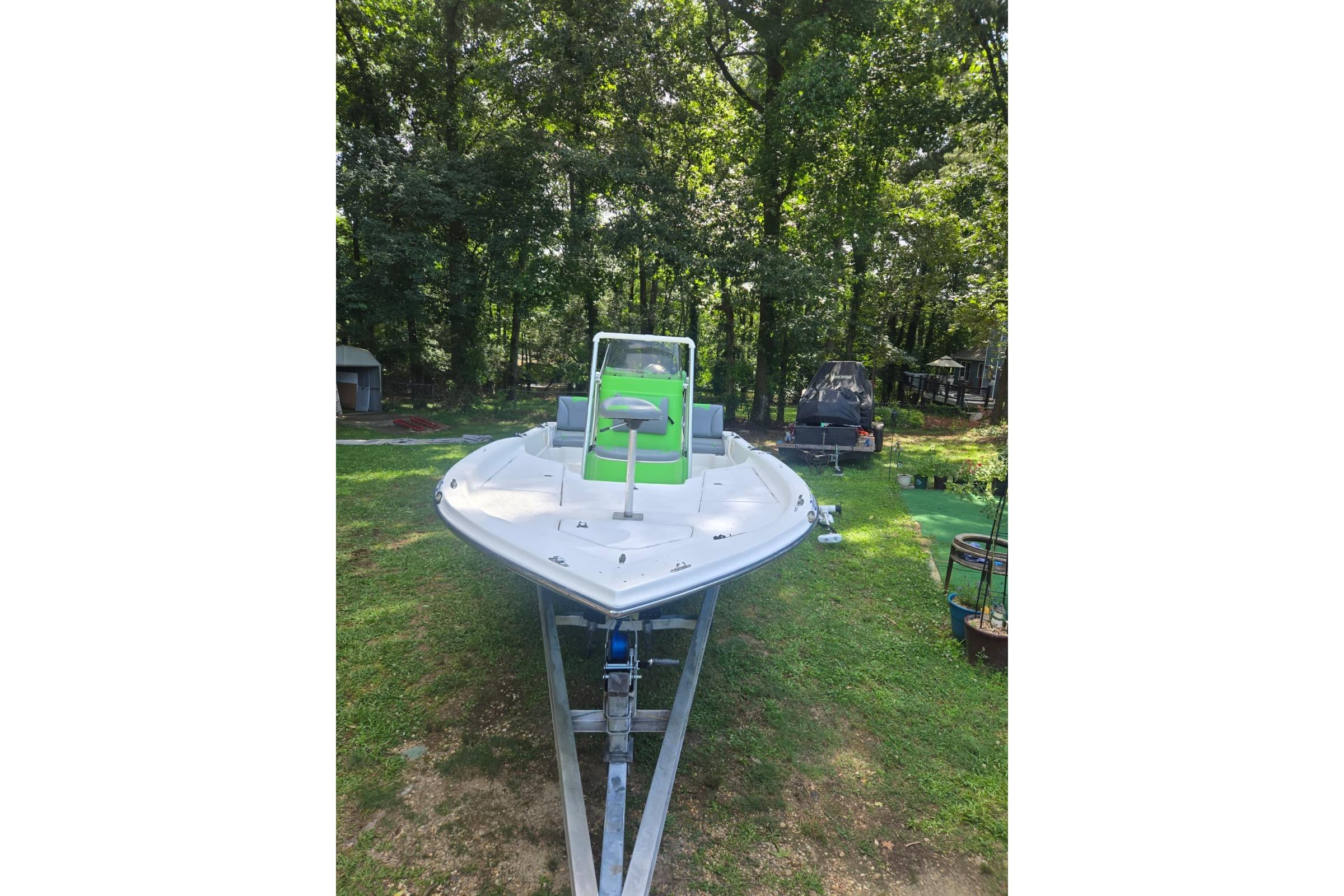 2016 Epic 21 Sport Console boat on trailer in a wooded area.