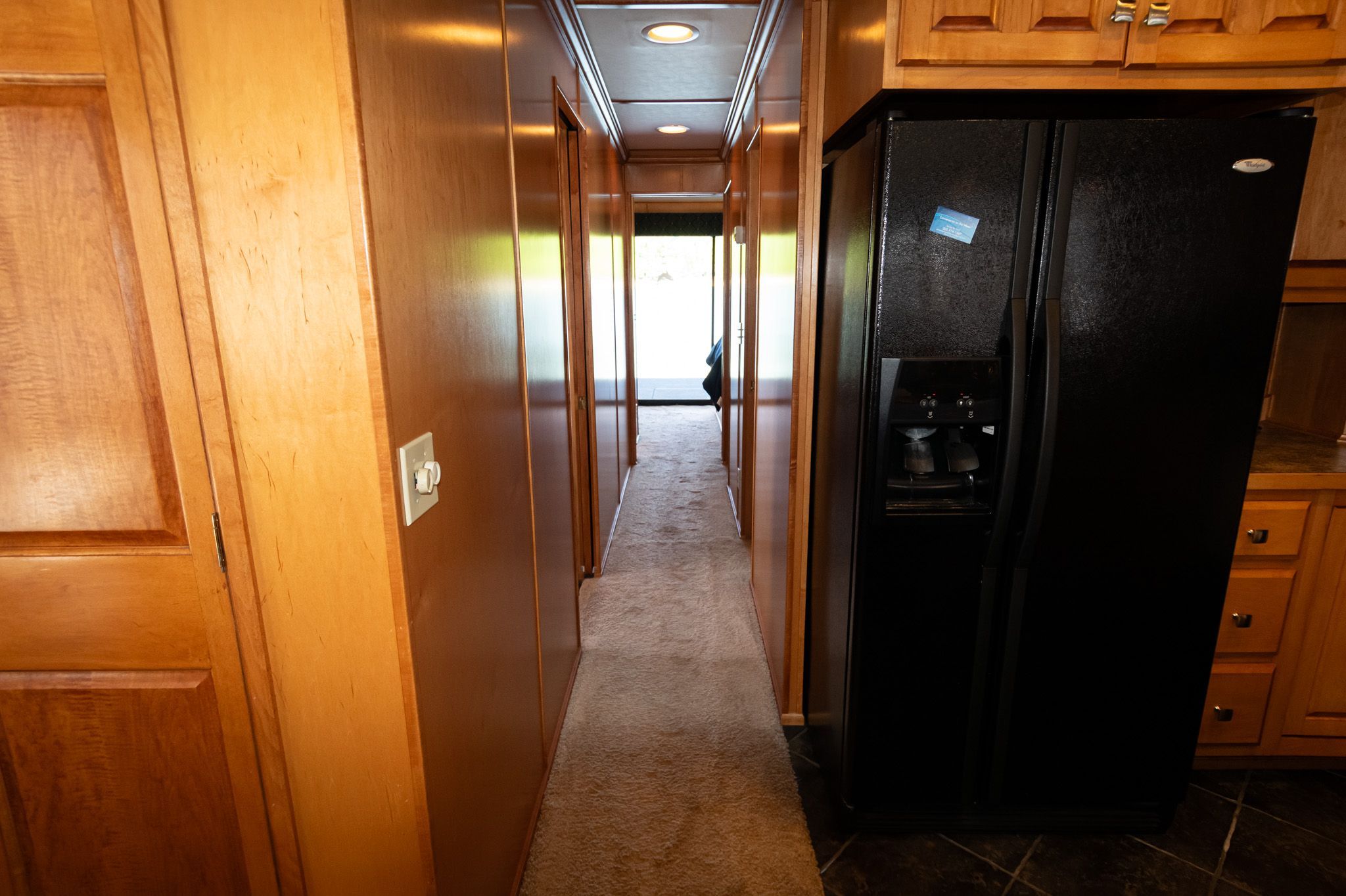 Interior of a 2003 Lakeview 16x70 houseboat with black refrigerator.