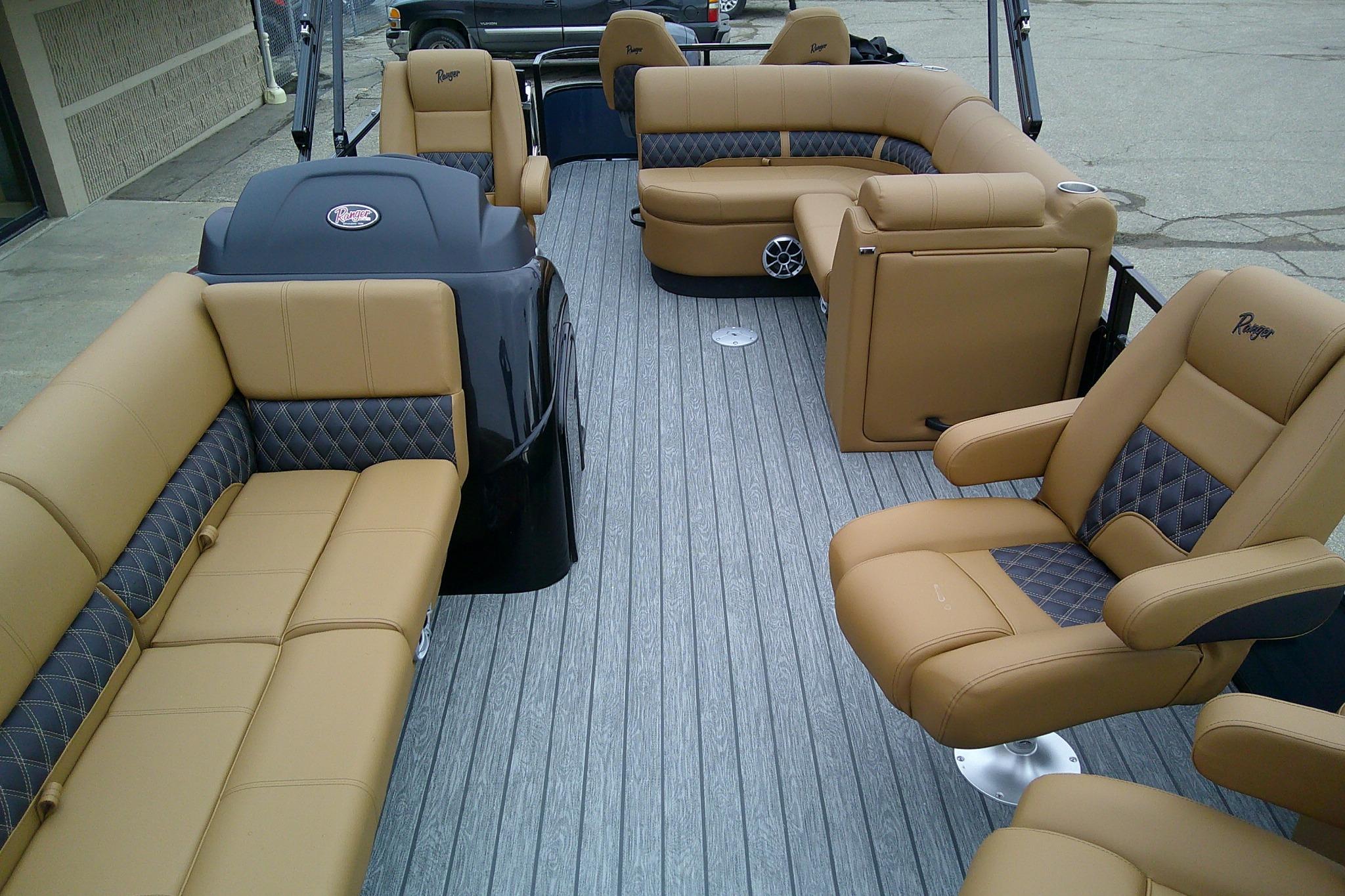 Luxurious interior of 2026 Ranger 220FC boat with tan leather seating and modern design.