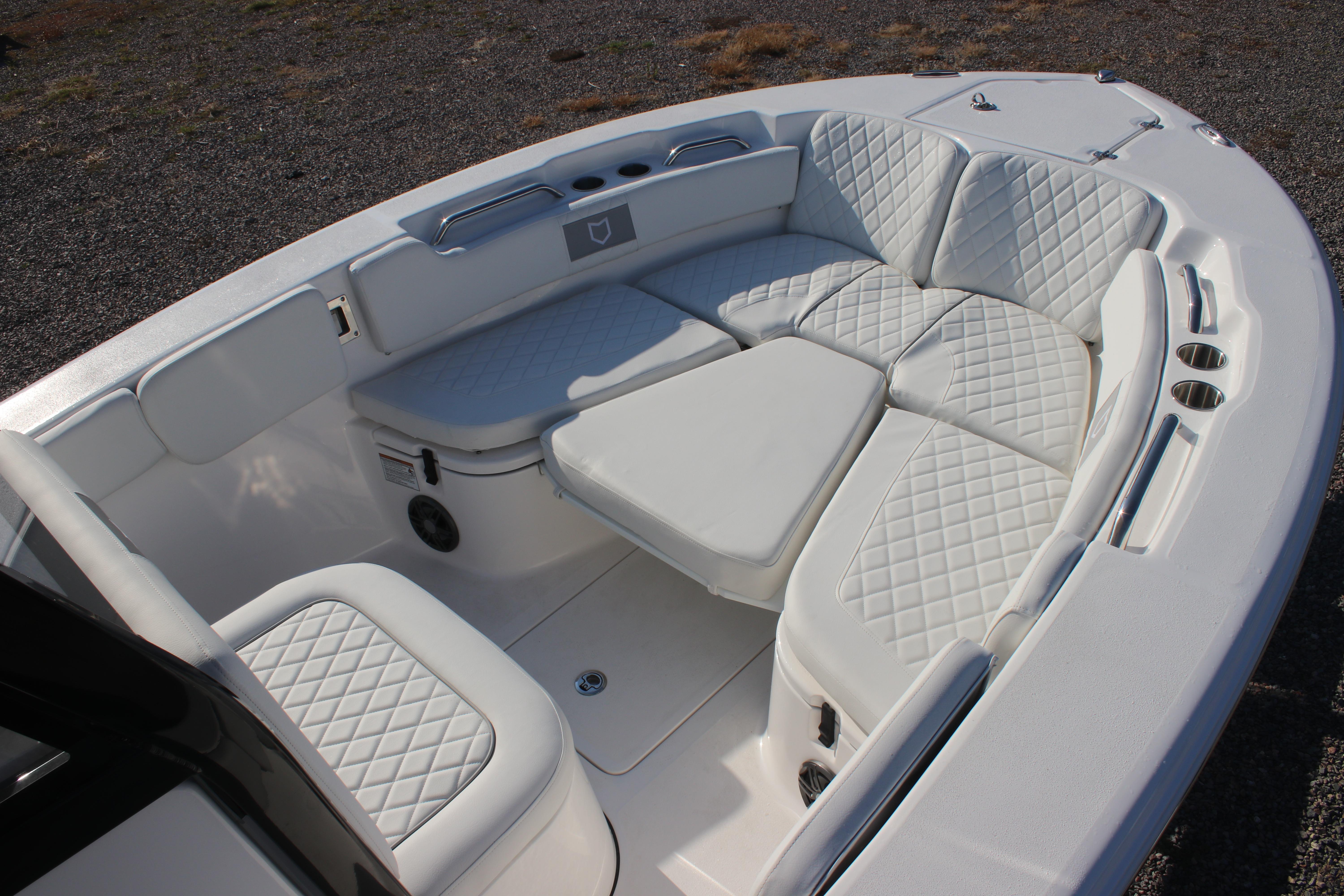 2026 Sea Fox 248 Commander boat interior with white cushioned seating and diamond stitching.