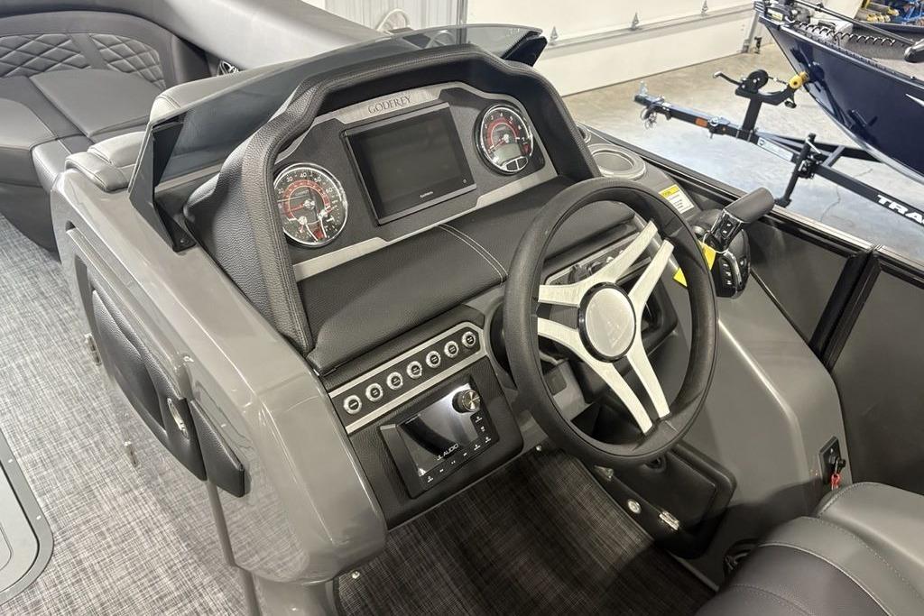 2026 Godfrey Monaco 235 SFLC iMPACT 2.0 boat dashboard with steering wheel and controls.