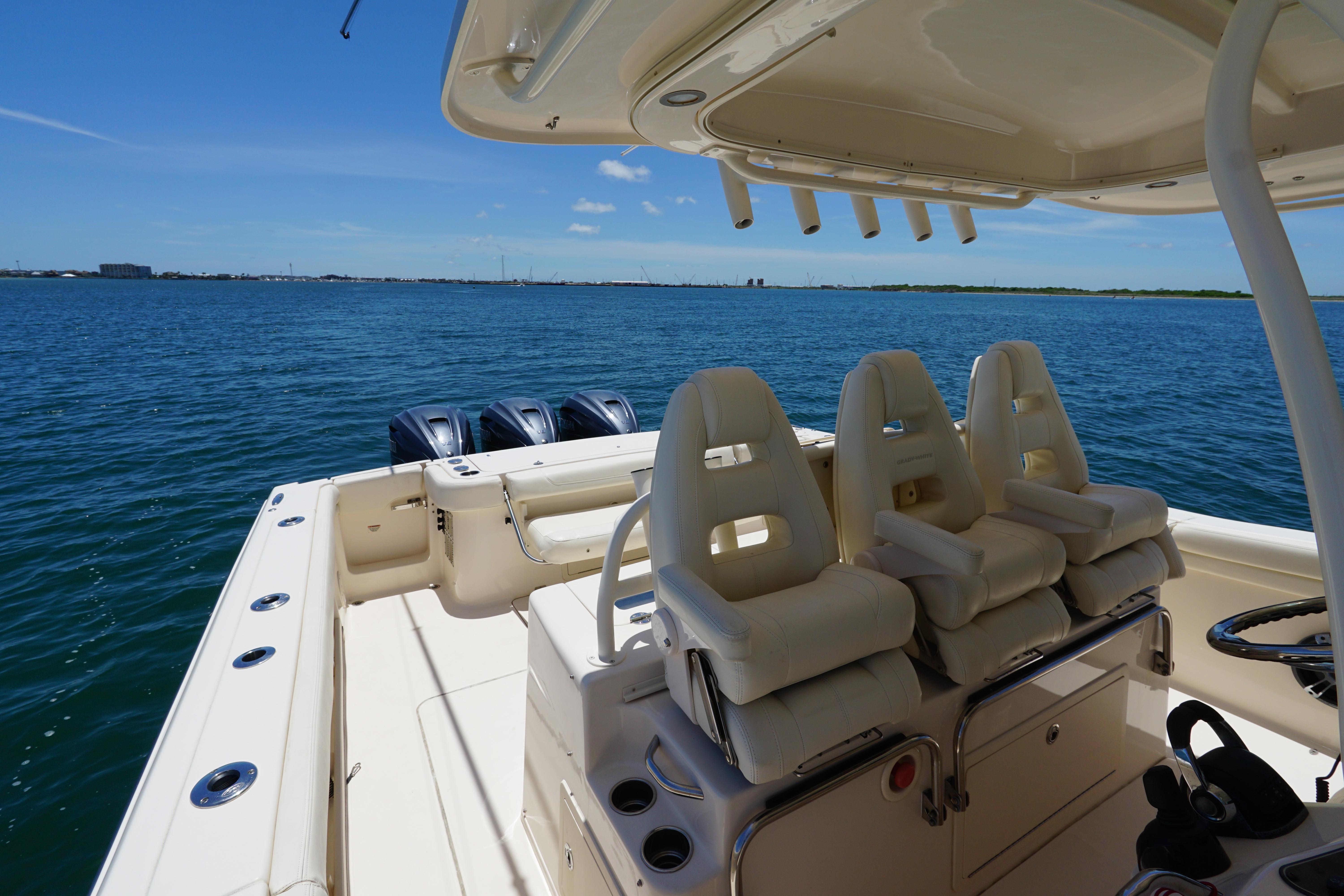 2020 Grady-White Canyon 376 boat interior with seating, ocean view, and triple outboard motors.