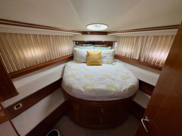 Luxurious bedroom in a 2002 Carver 570 Voyager Pilothouse yacht.