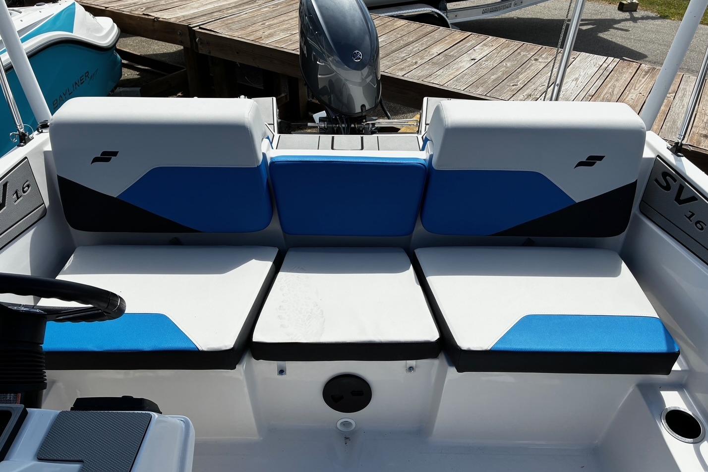 2026 Starcraft SV 16 OB boat interior with blue and white seating, docked by wooden pier.