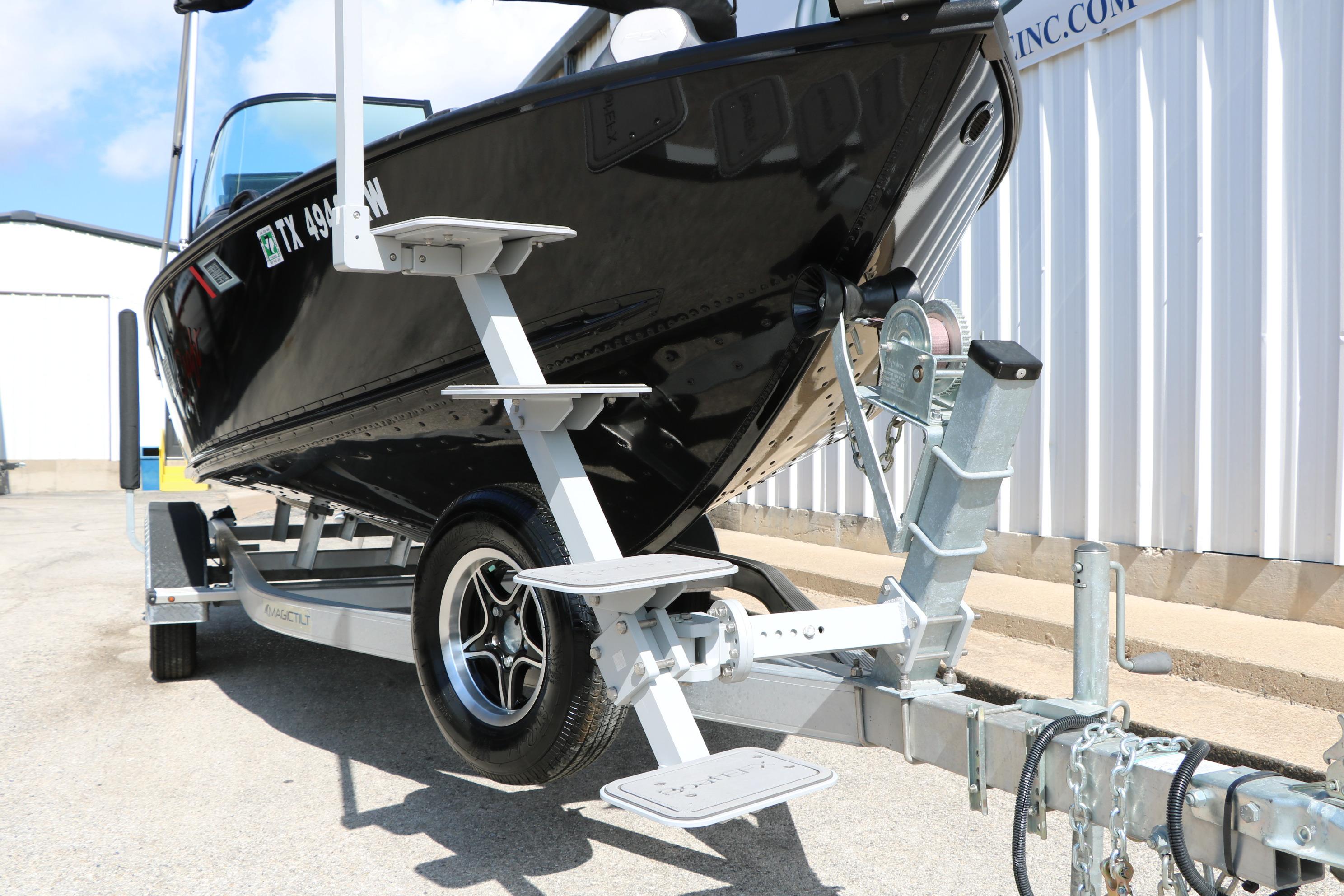 2023 Alumacraft Competitor FSX 185 boat on trailer, parked outdoors.