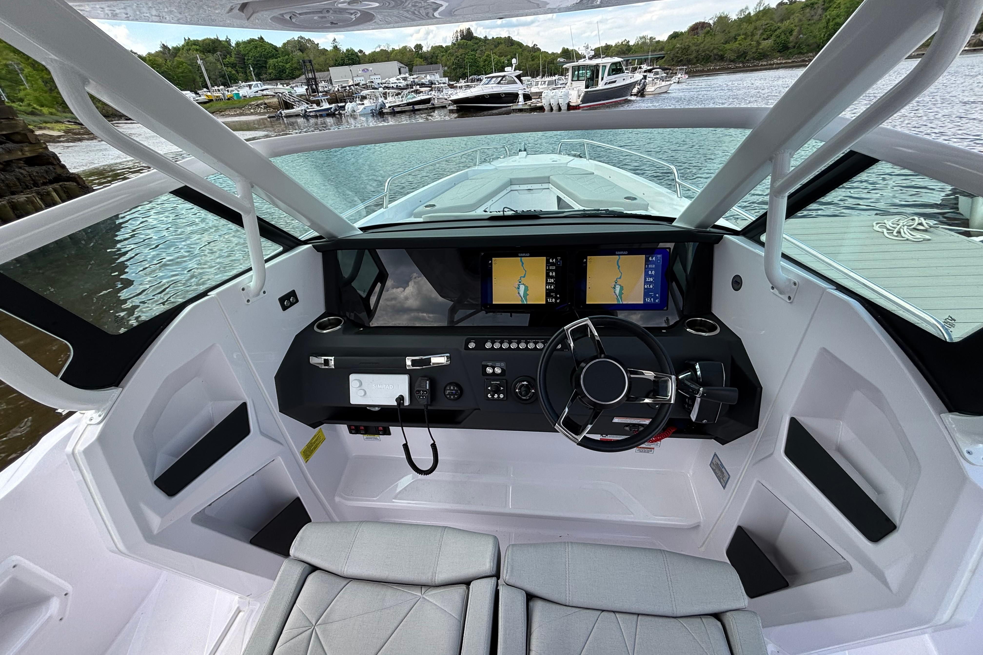 Interior view of 2025 Axopar 29 Sun-Top boat cockpit with modern navigation system.