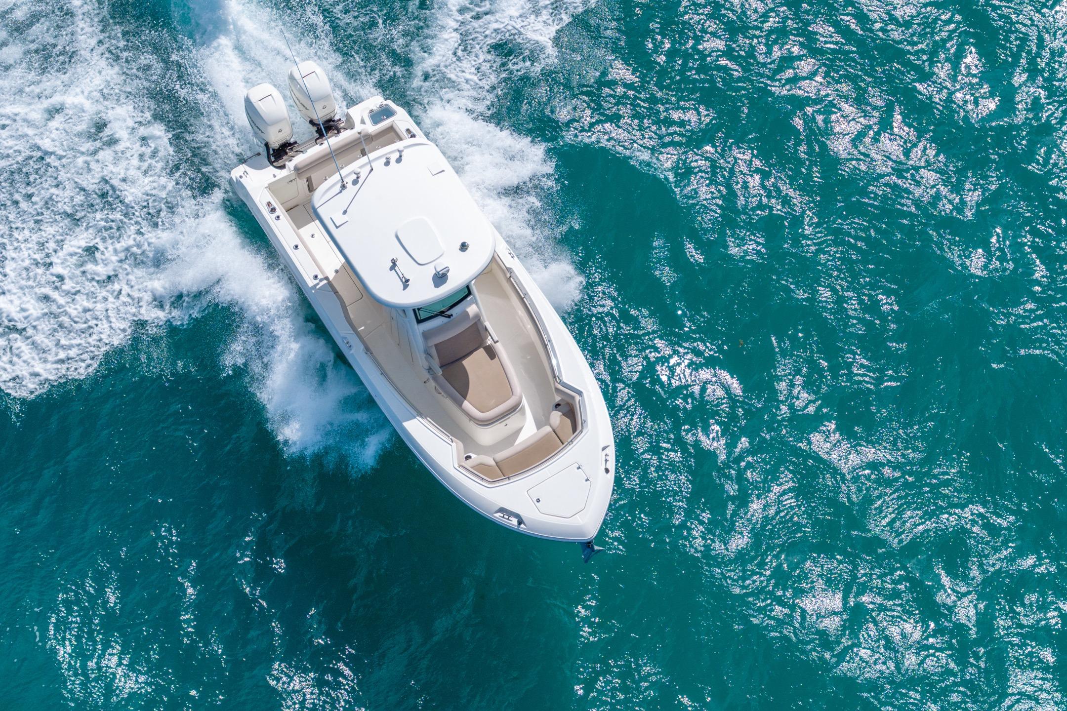 2016 Boston Whaler 280 Outrage cruising on vibrant blue ocean waters.