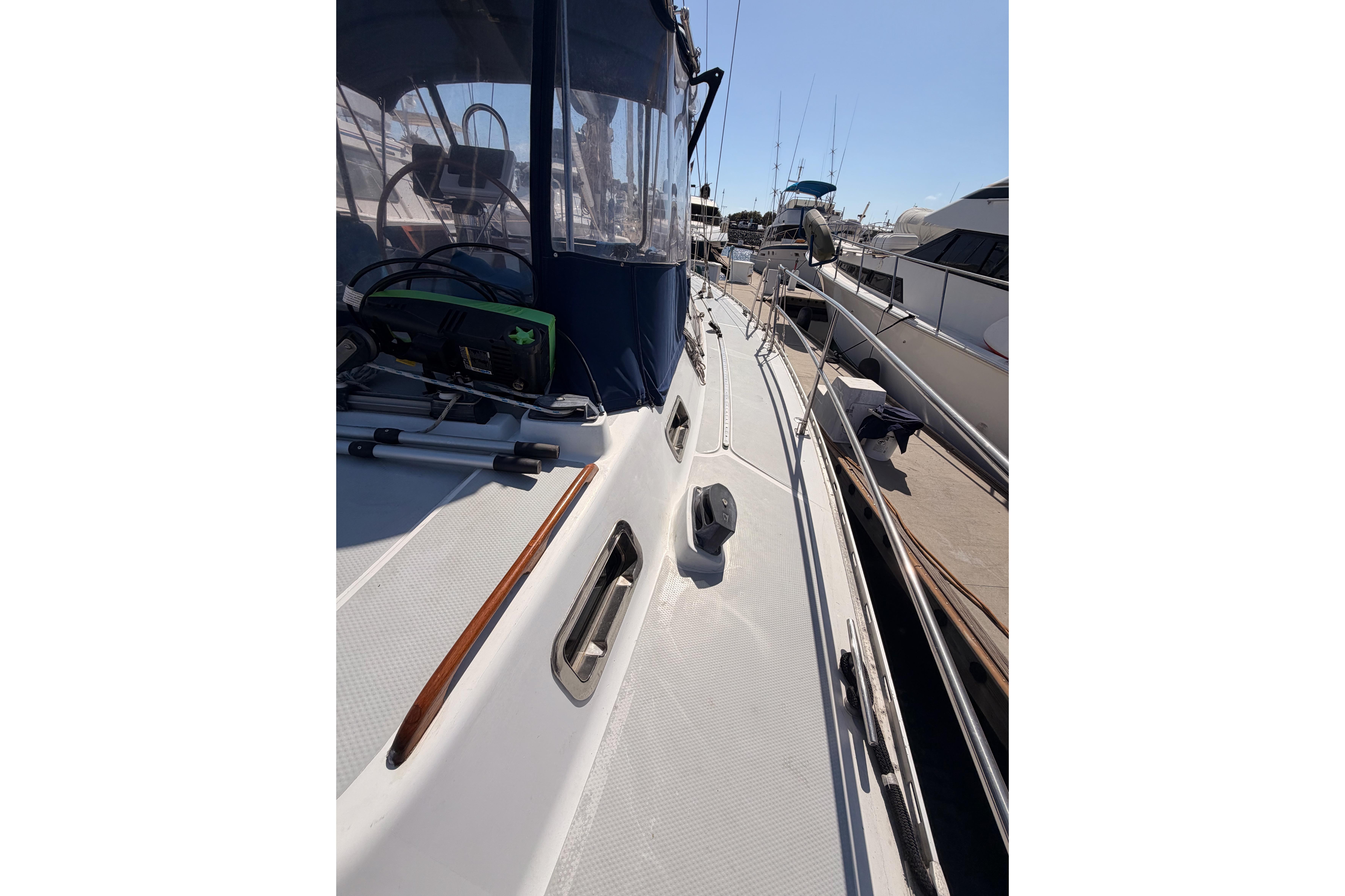 Sailboat deck view of 1991 Hylas 51, docked with clear skies.