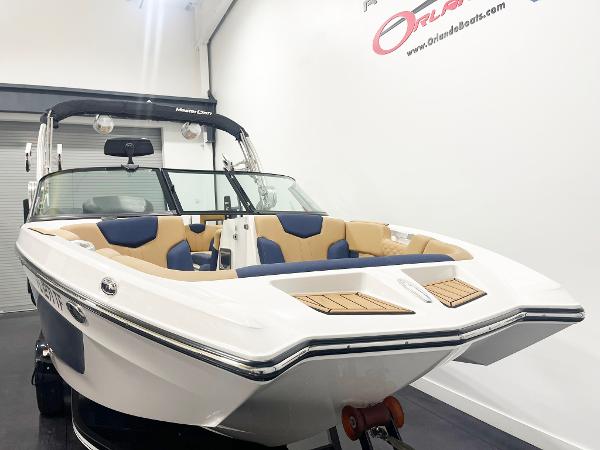 2022 MasterCraft NXT24 boat with sleek design and spacious seating in showroom.